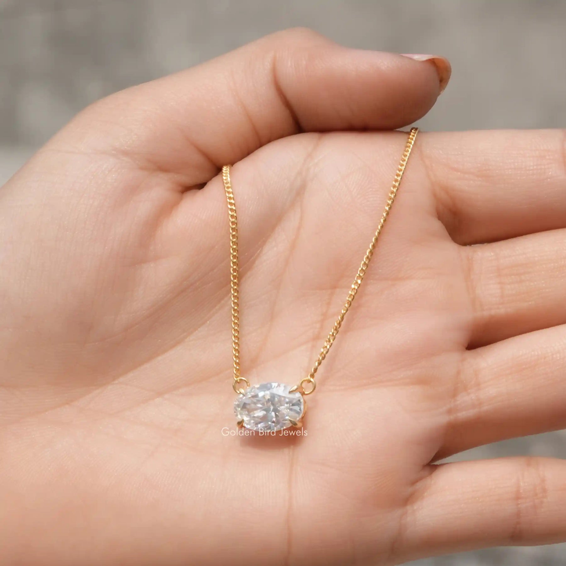 In hand showing a view of moissanite pendant