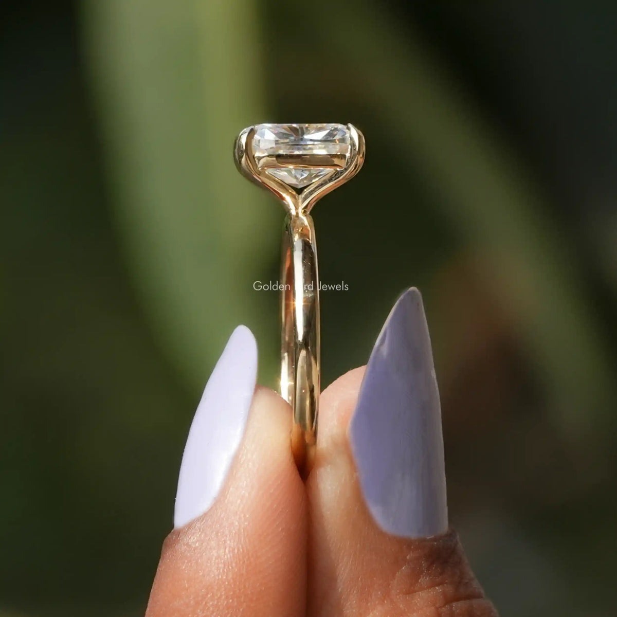 Side View of Cushion Cut Solitaire Moissanite Ring In two fingers