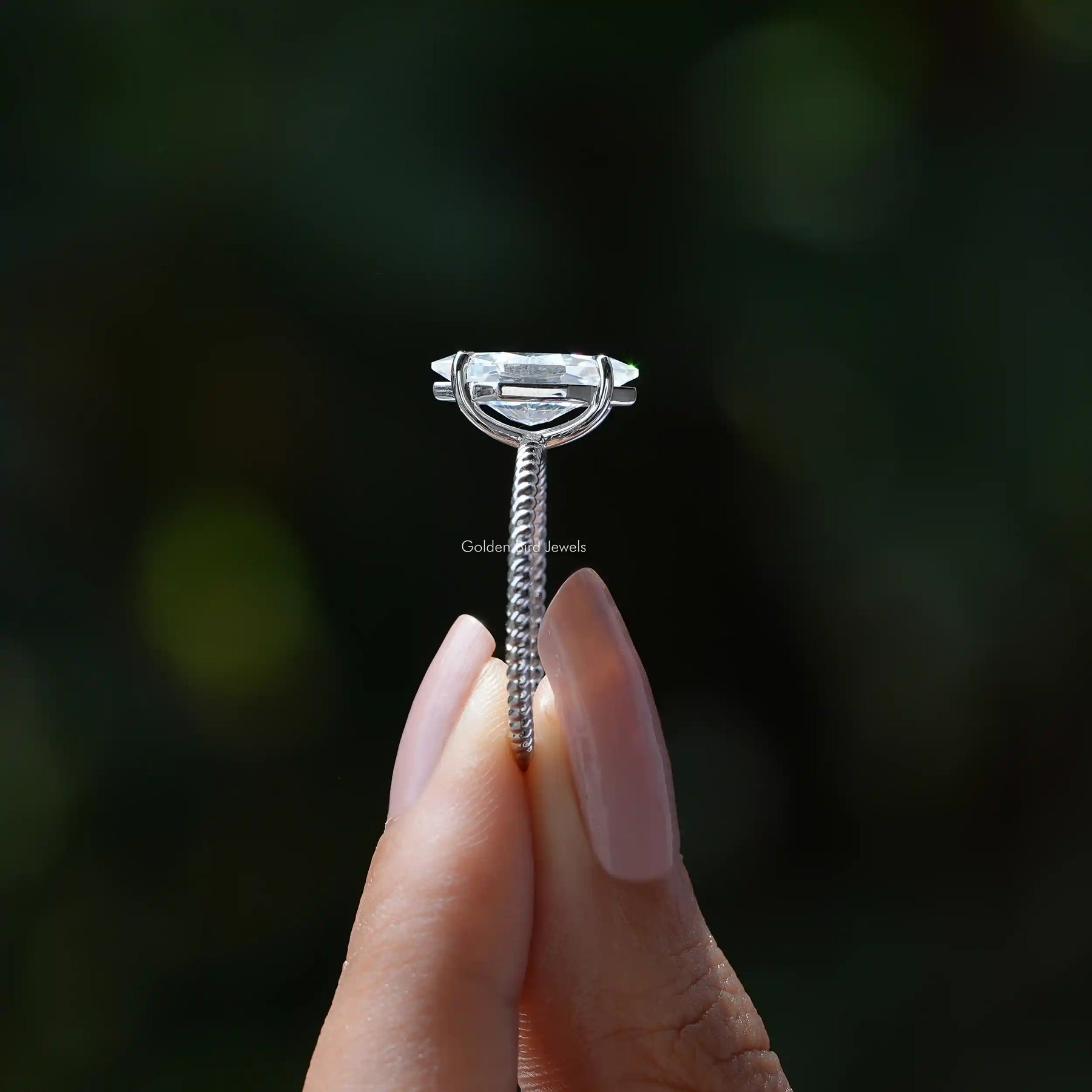 Side View of Dutch Marquise Cut Engagement Ring In two fingers