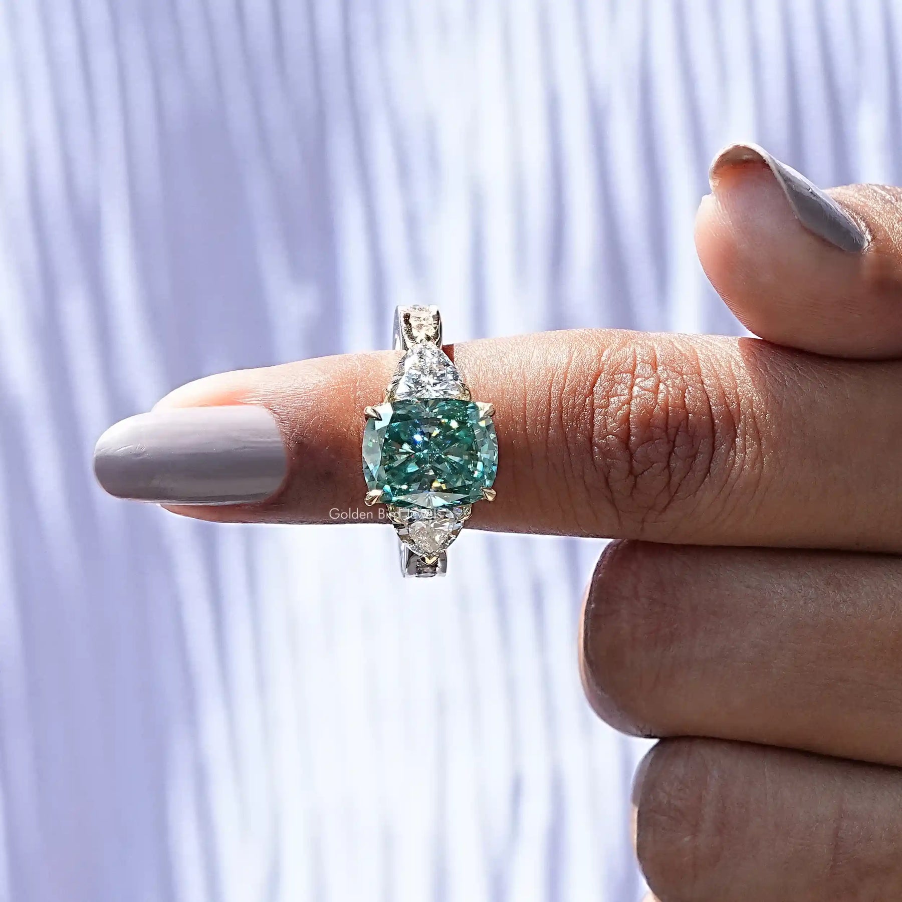 In finger front View of 3 Stone Cushion Cut Moissanite Accent Stone Ring