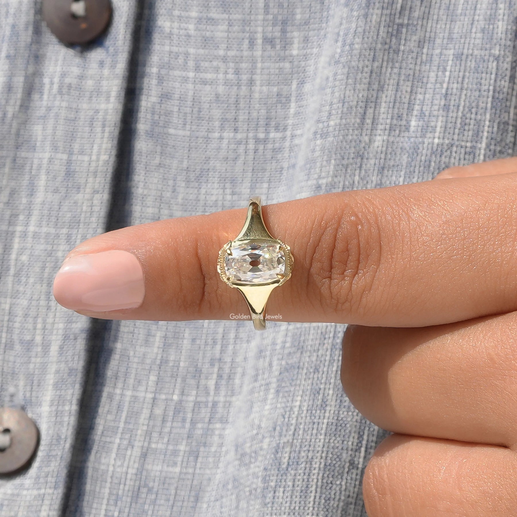 In finger front View of Cushion And Round Cut Moissanite Ring In Yellow Gold