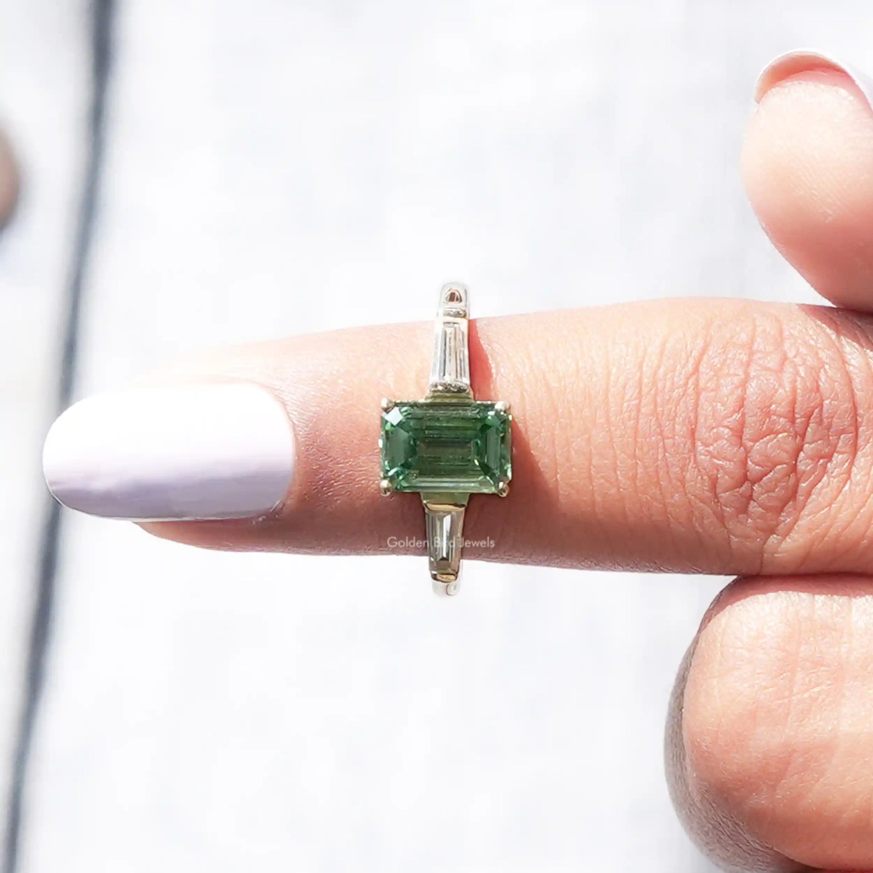 In finger front View of Emerald Cut Moissanite Prong Set Ring