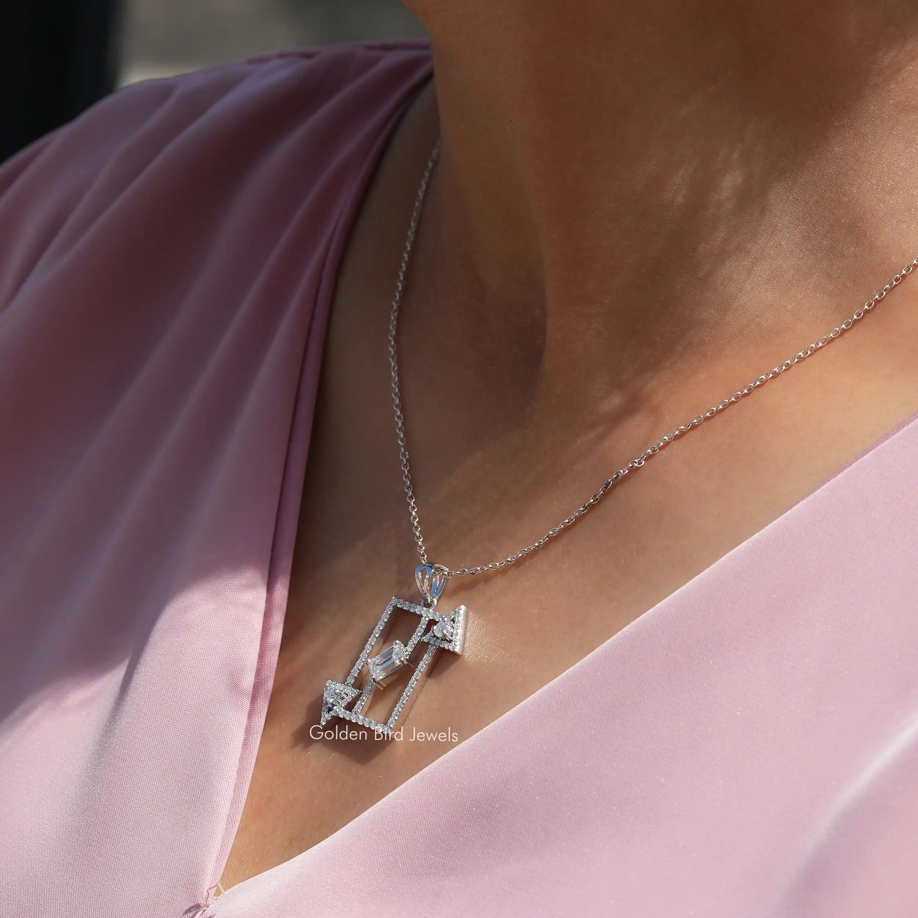 Side view of emerald cut pendant In white Gold