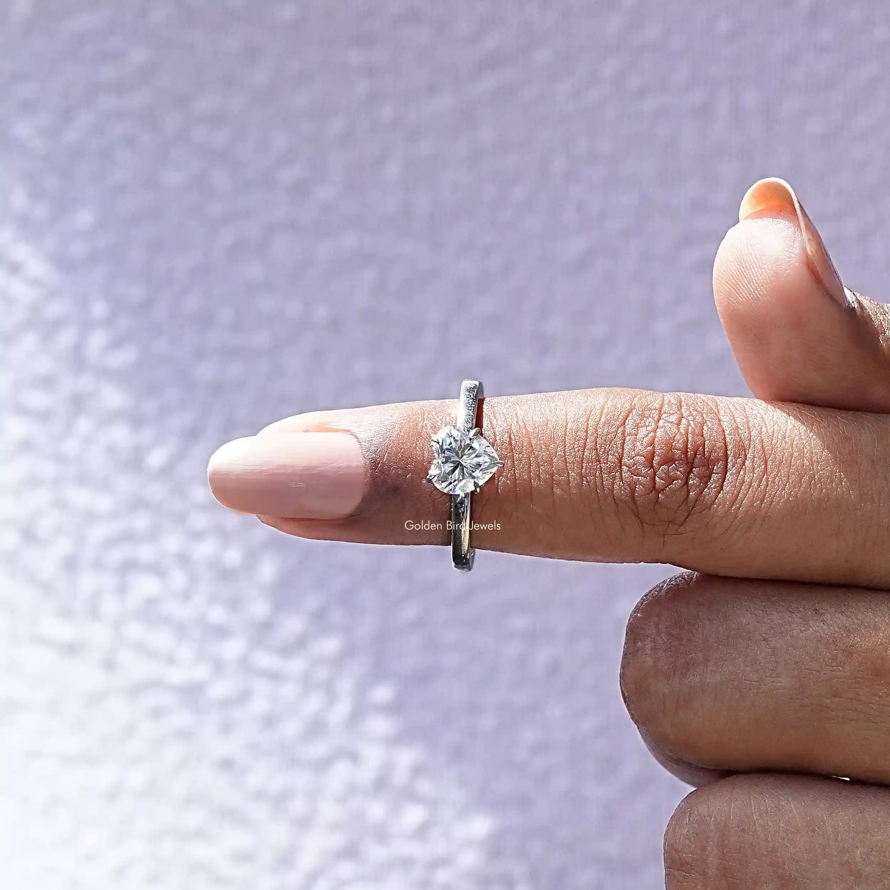 In finger front view of Moissanite Heart Cut Hidden Halo Ring In White Gold