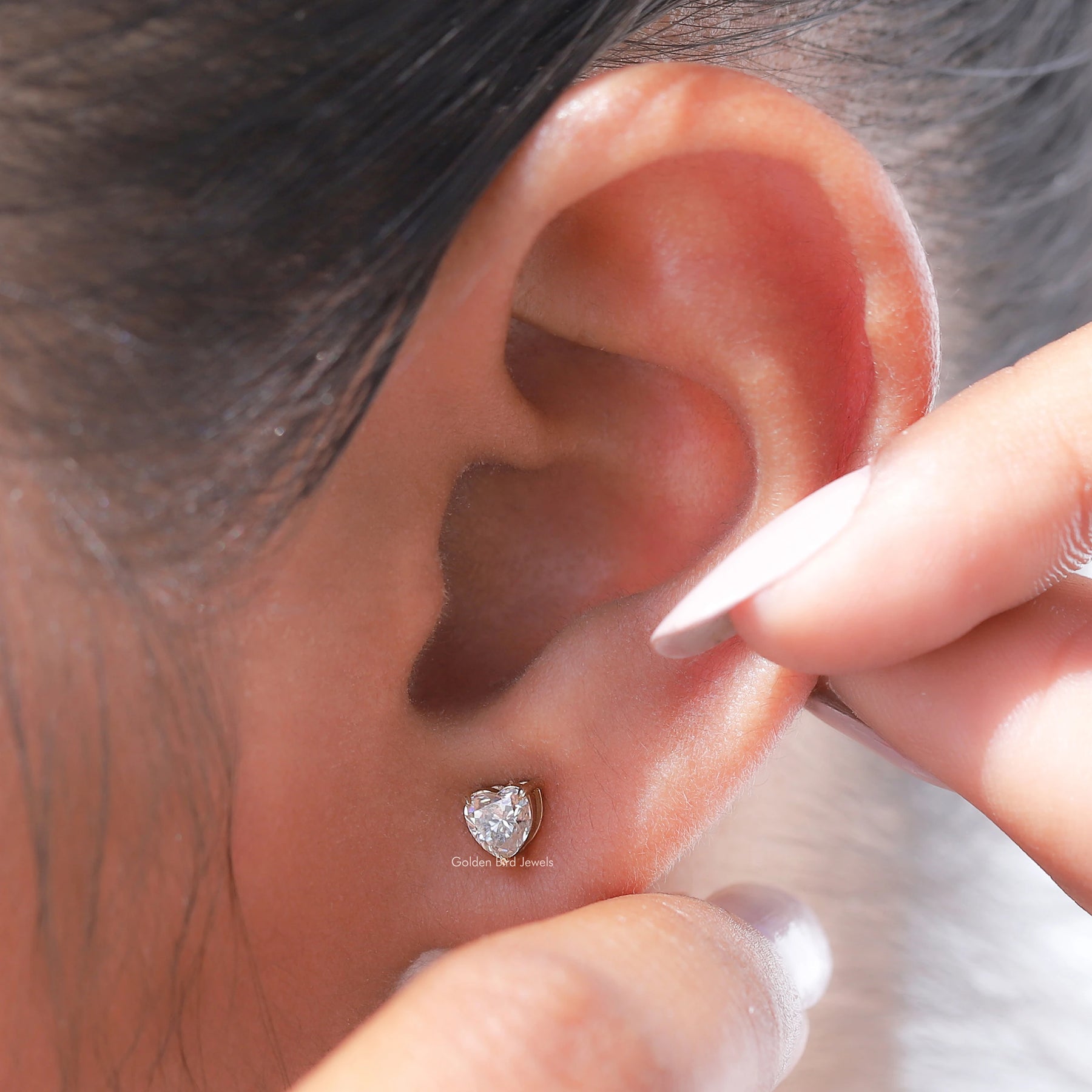 Front view of heart cut moissanite stud earrings in yellow gold