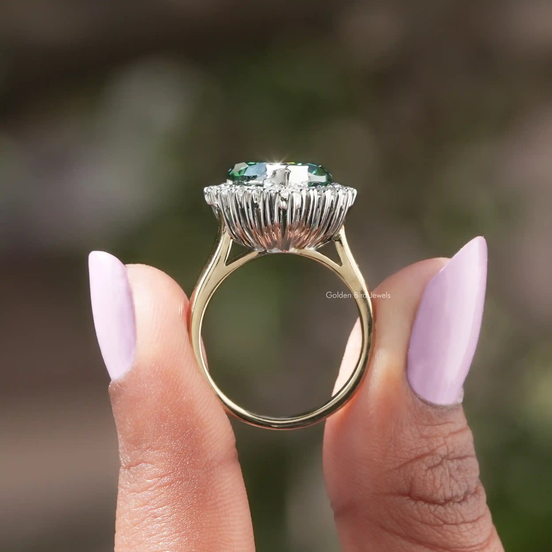 Back View of Green Moissanite Heart Cut Halo Engagement Ring In two fingers