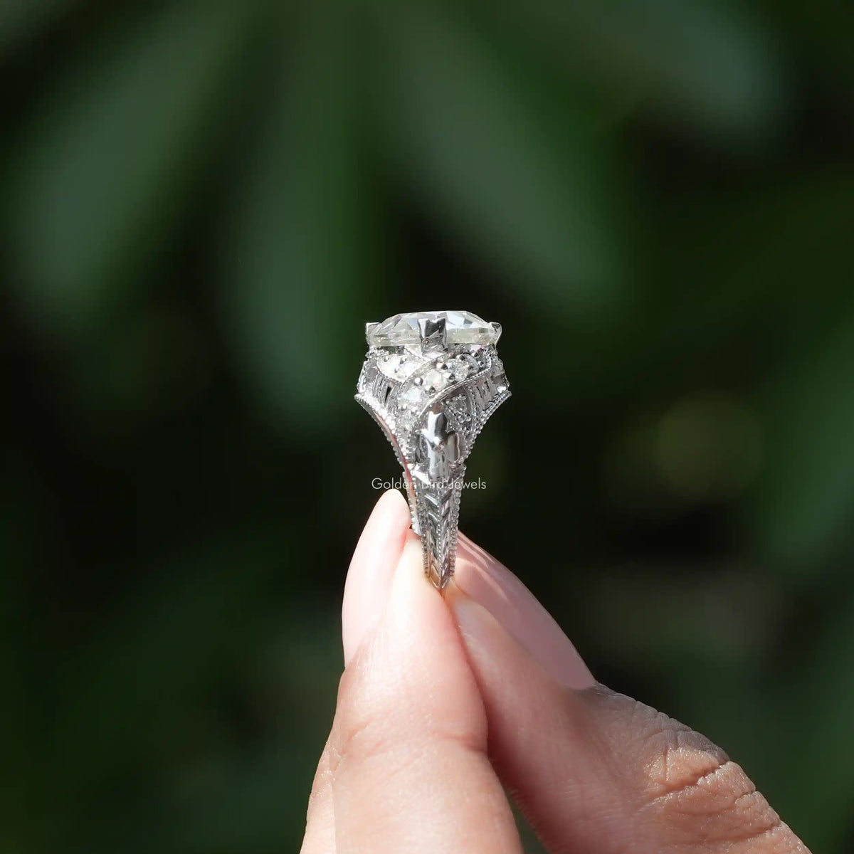 Side View of Moissanite Old European Round Cut Ring In two fingers