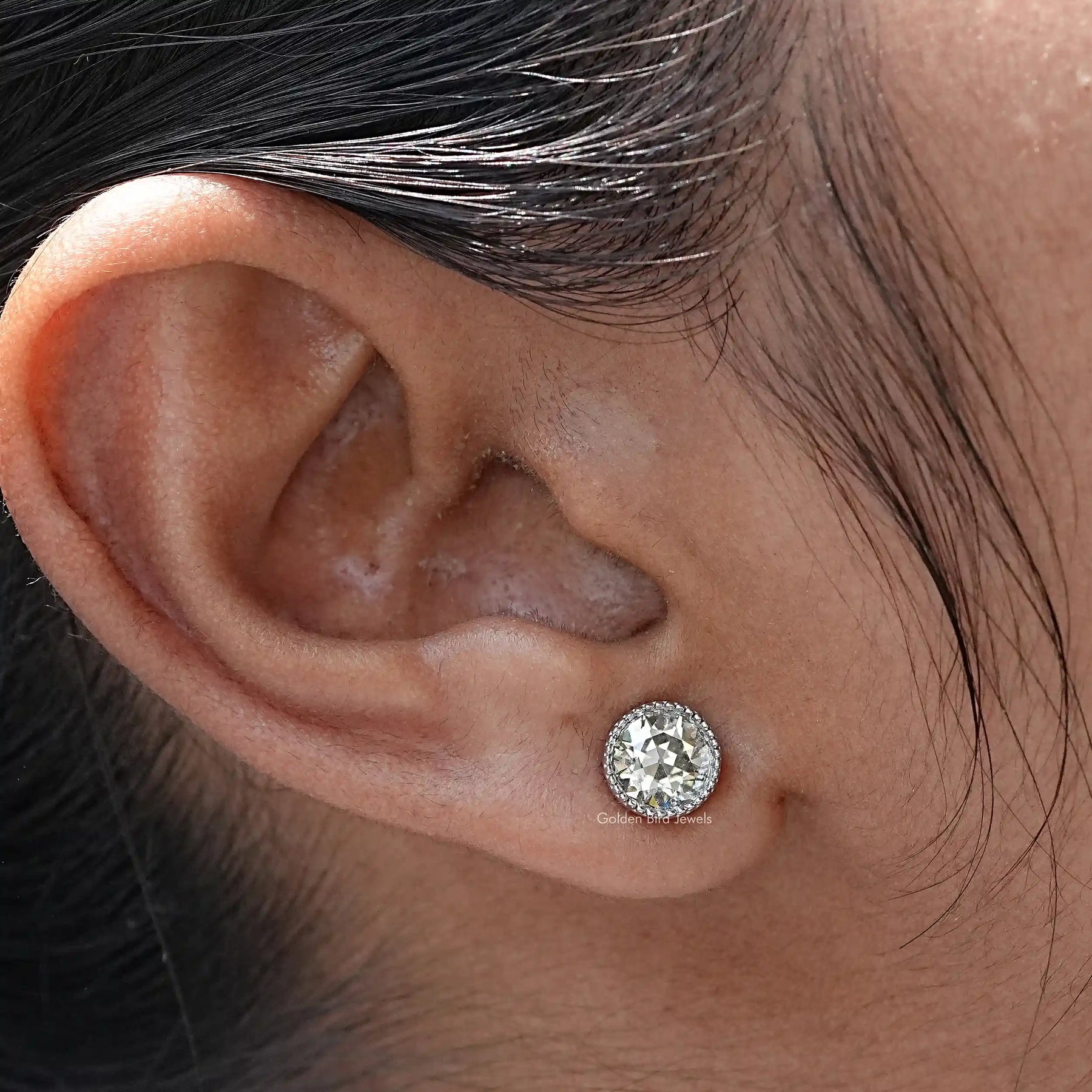 In close ear view of Round Cut Moissanite Stud Earrings