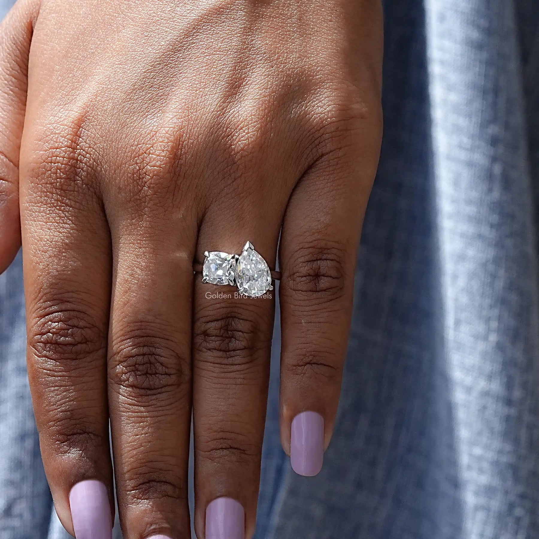 View of Old Mine Cushion And Old Mine Pear Cut Ring In Finger