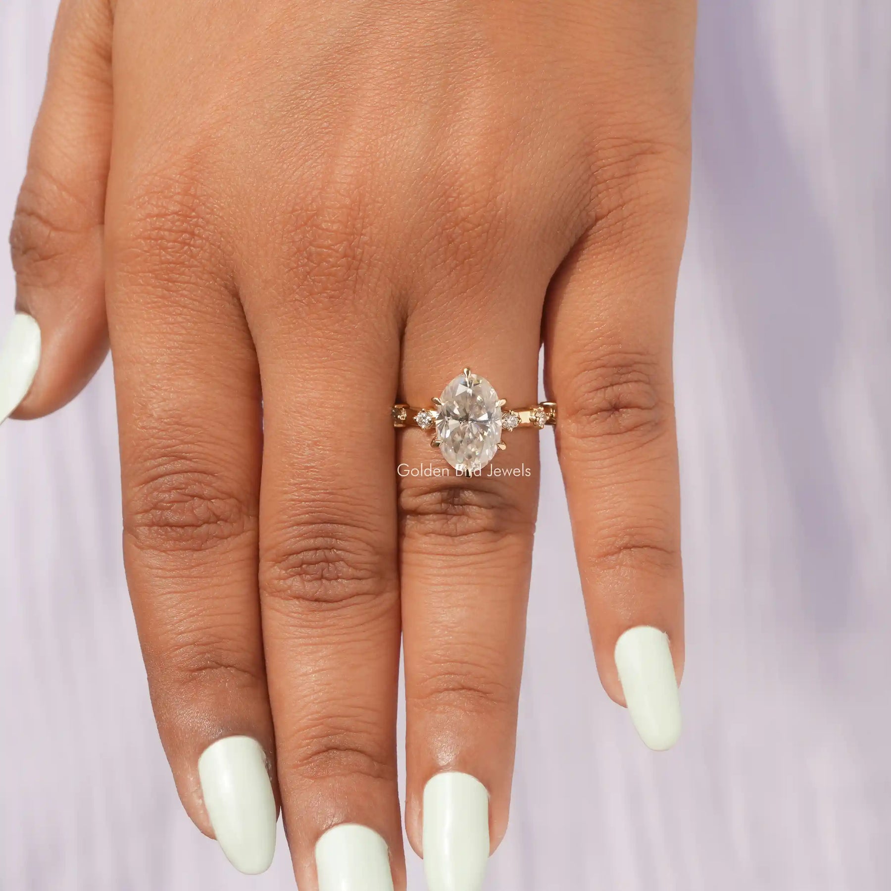 Close-Up View of Moissanite Oval Cut Accent Stone Ring In Yellow Gold