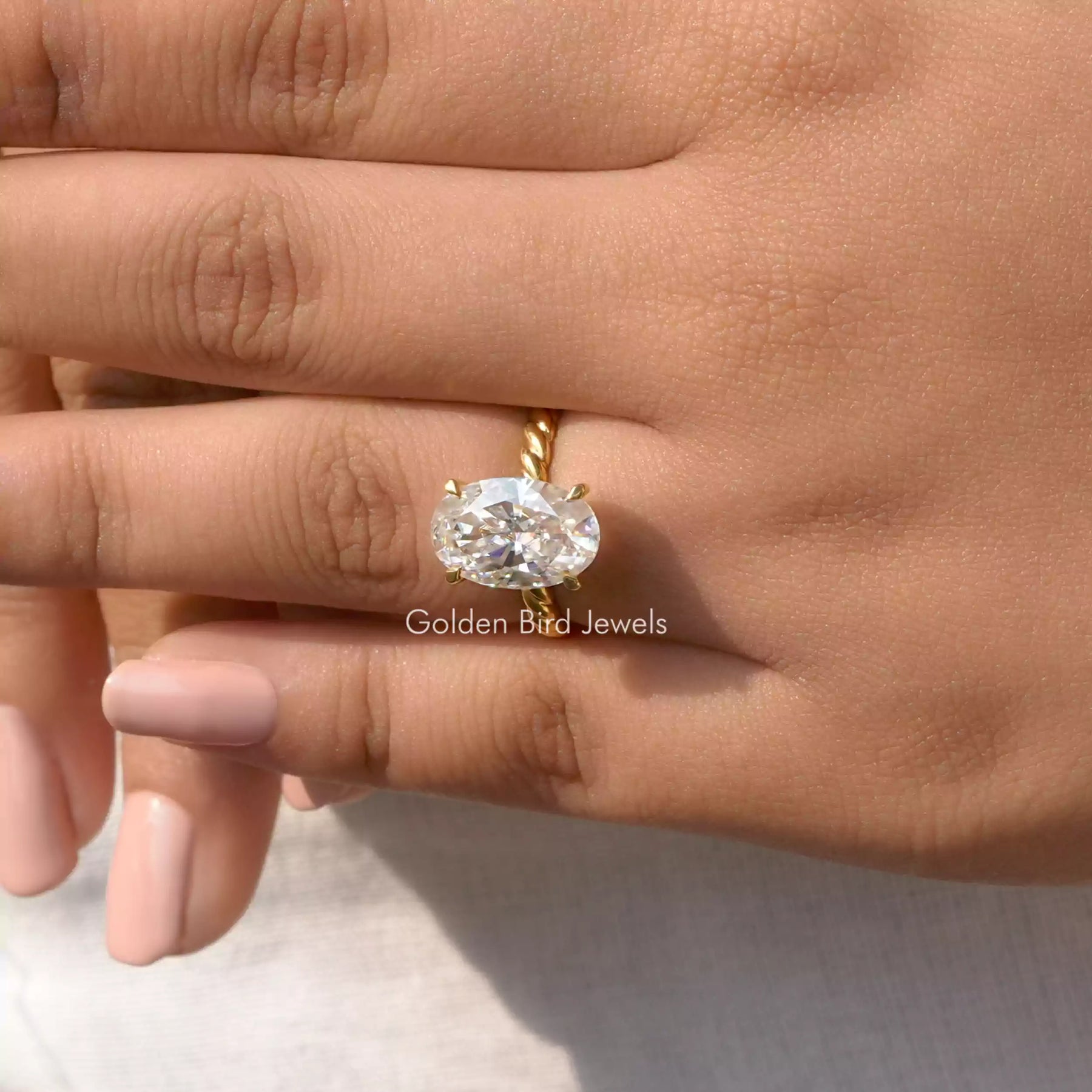 Close-Up View of Moissanite Oval Cut Engagement Ring In Yellow Gold