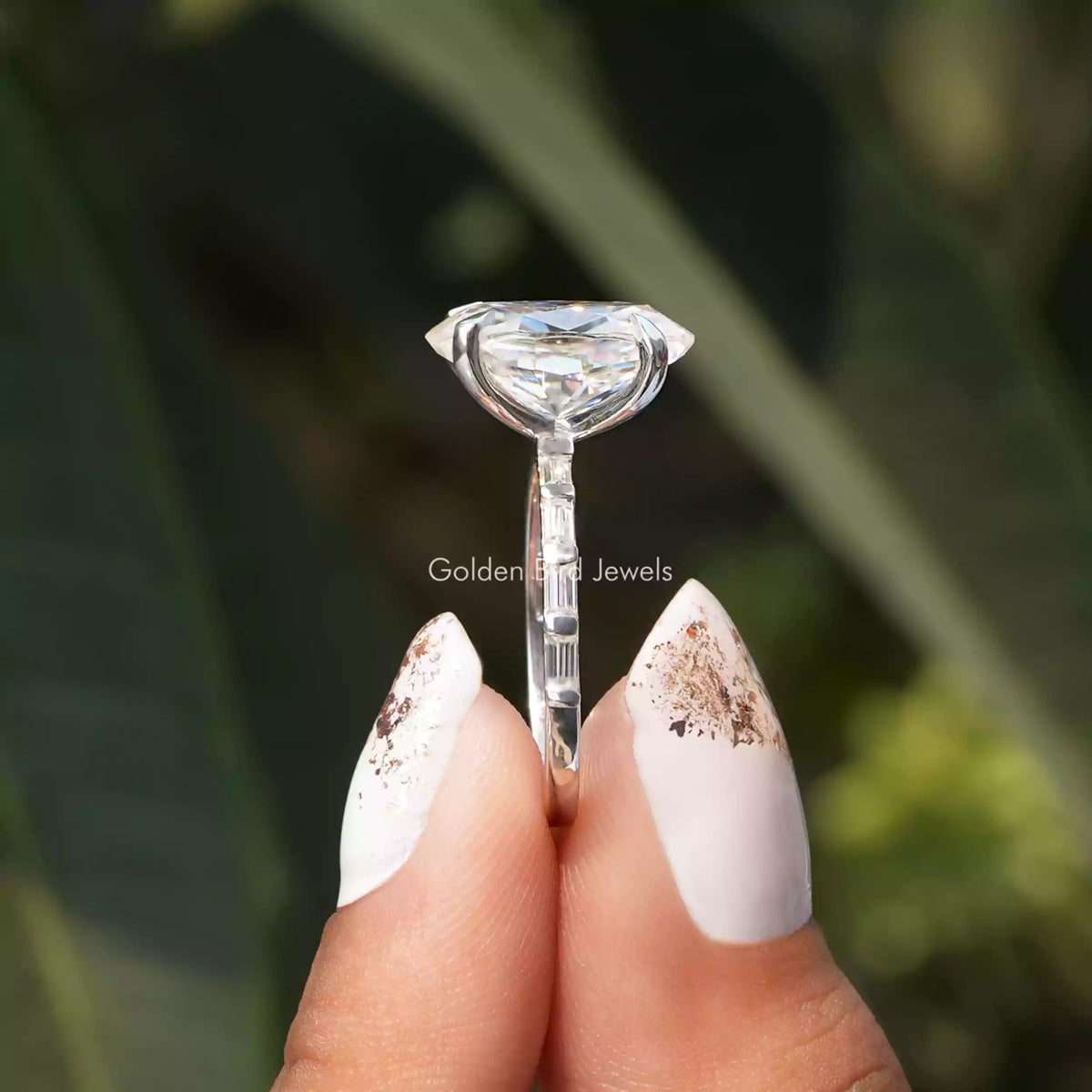 Side View of Oval Cut Moissanite Ring In two fingers