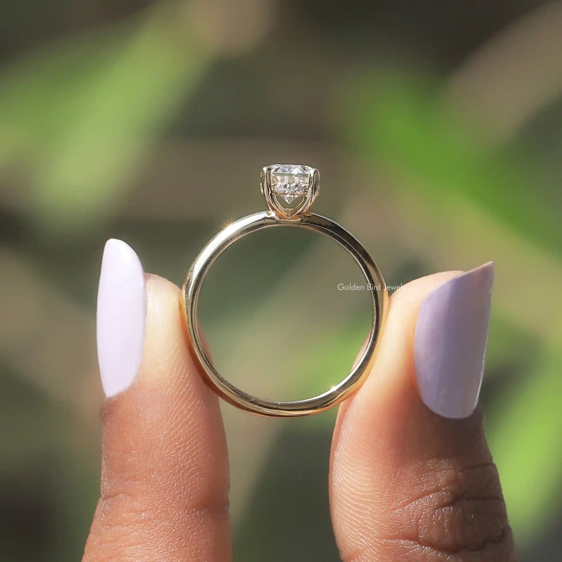 Back View of Oval Cut Moissanite Hidden Halo Ring In two fingers