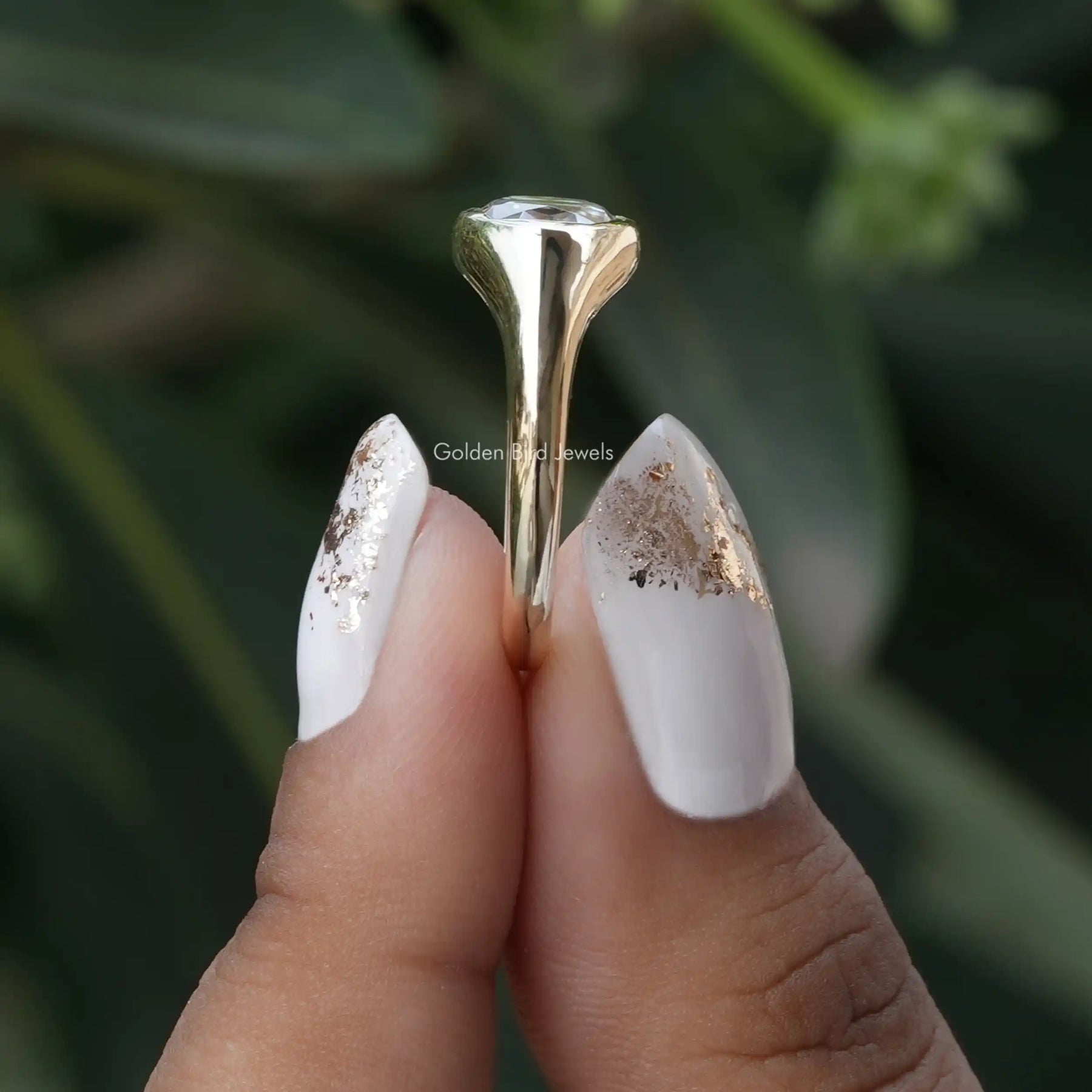 Side View of Rose Cut Oval Moissanite Engagement Ring In two fingers