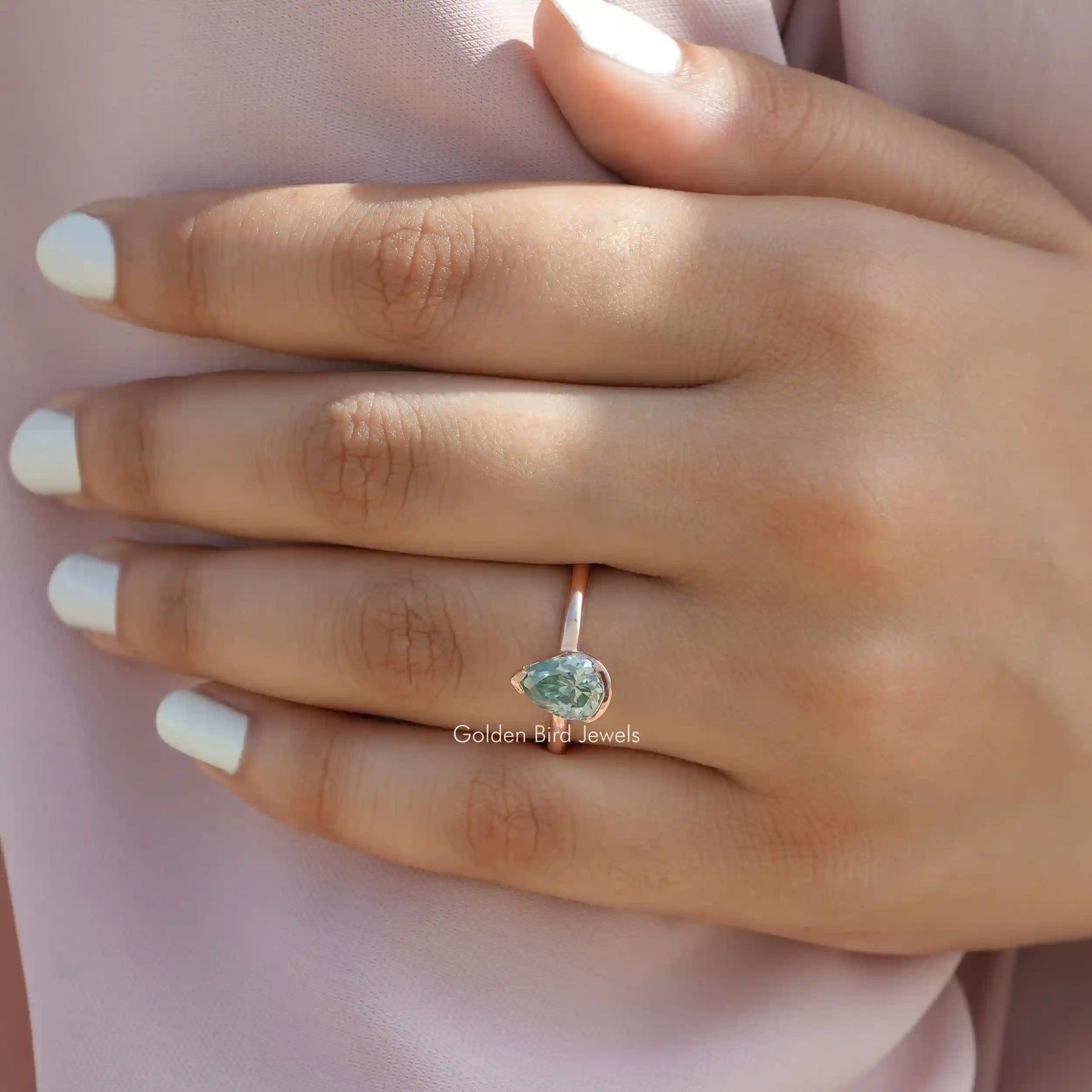 Close-Up View of Pear Cut Moissanite Engagement Ring In Yellow Gold