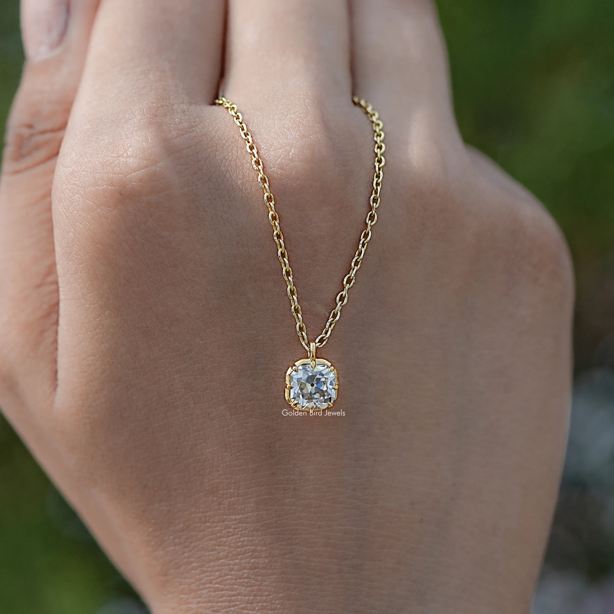 In hand Showing View Of Old Mine Cushion Moissanite Pendant