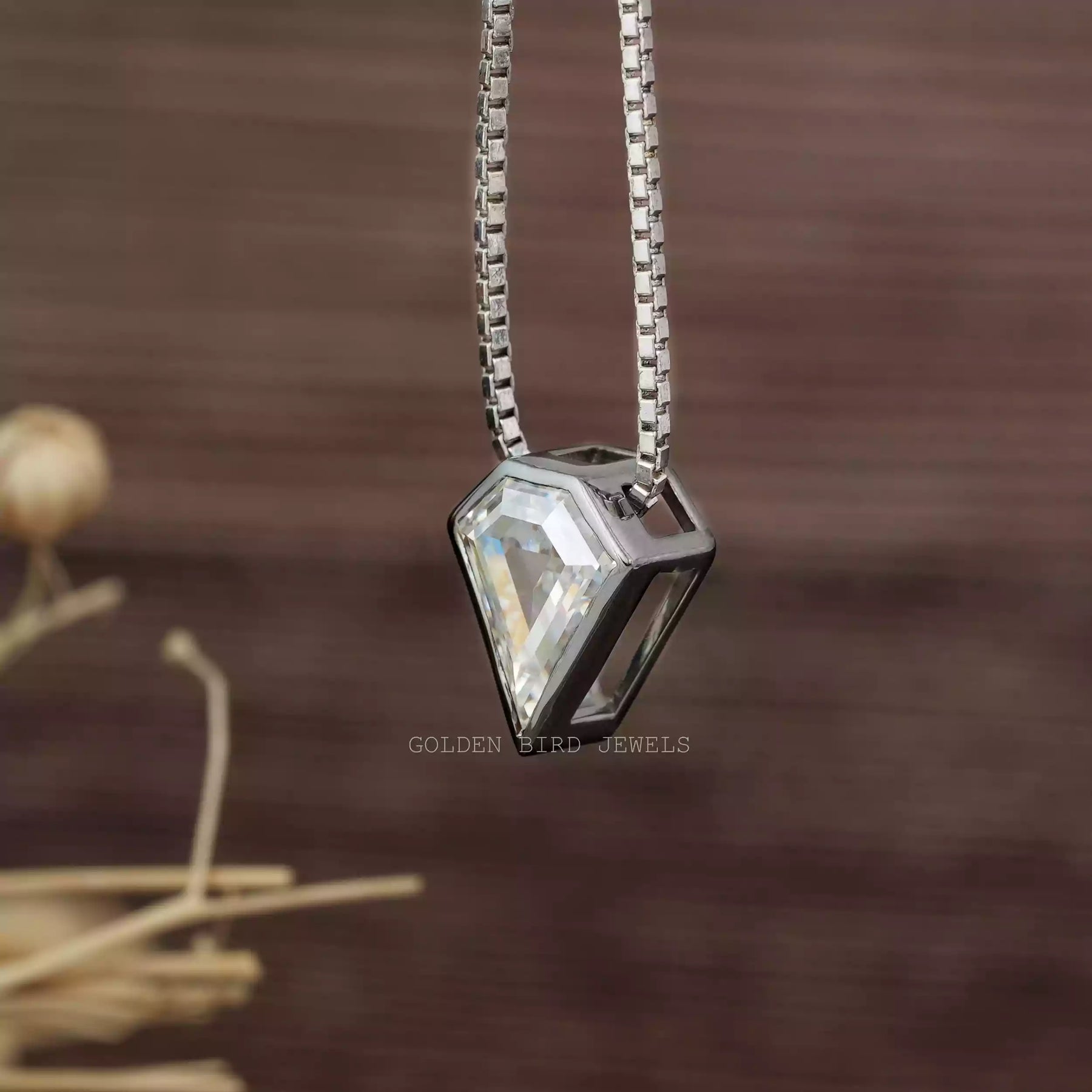 Side view of colorless pentagon cut pendant set in bezel setting