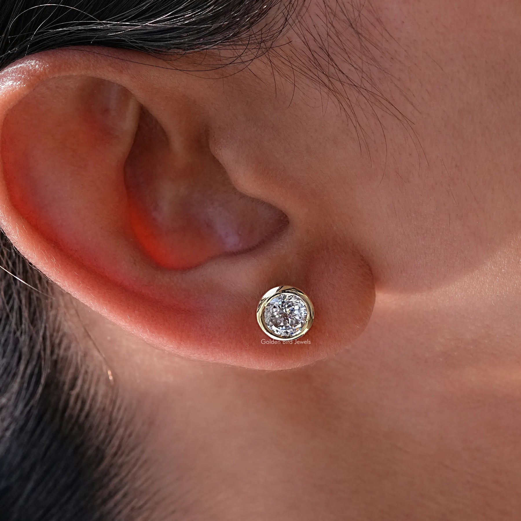 In side ear view of Round cut moissanite stud earings