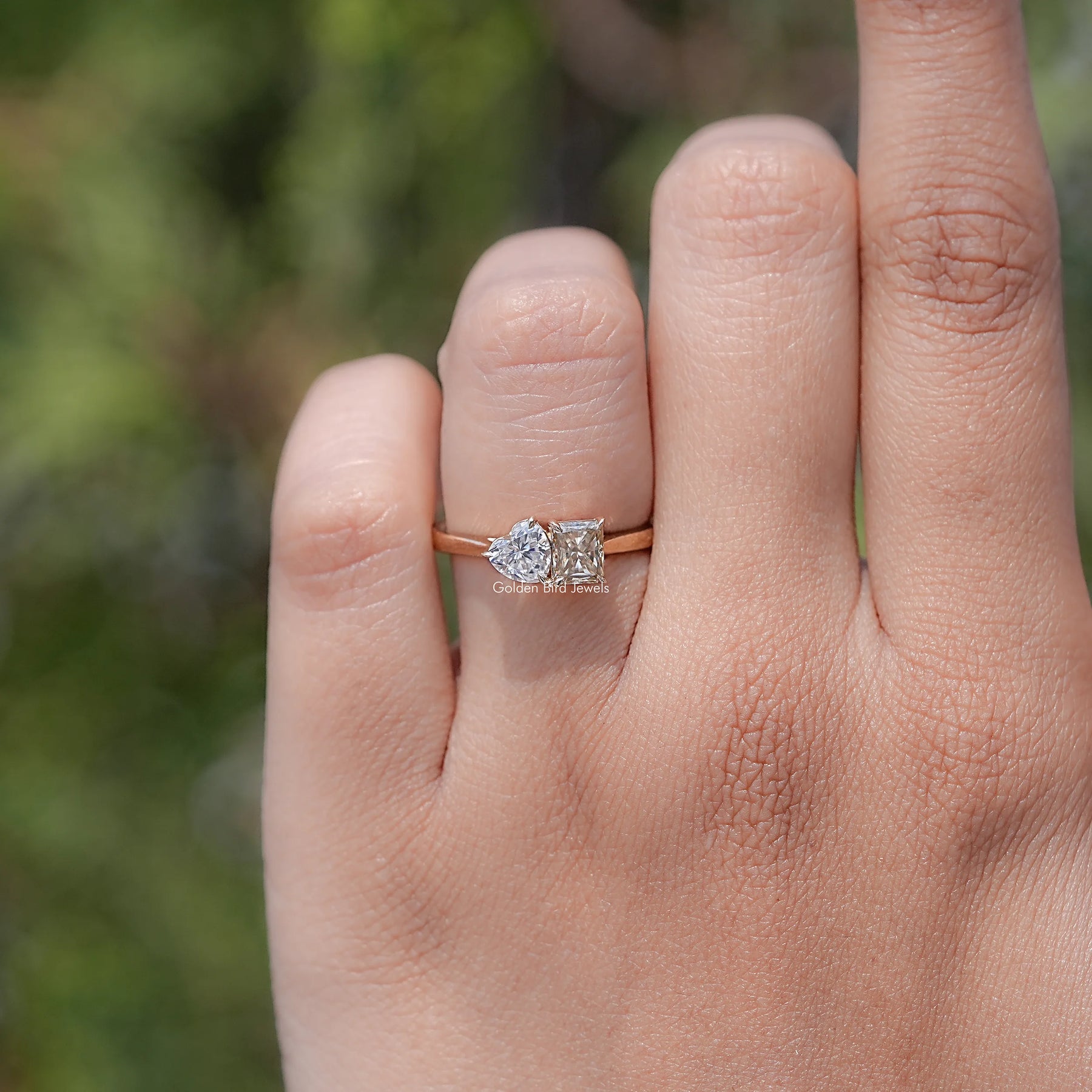 In finger view of Radiant And Heart Cut Moissanite Two Stone Ring
