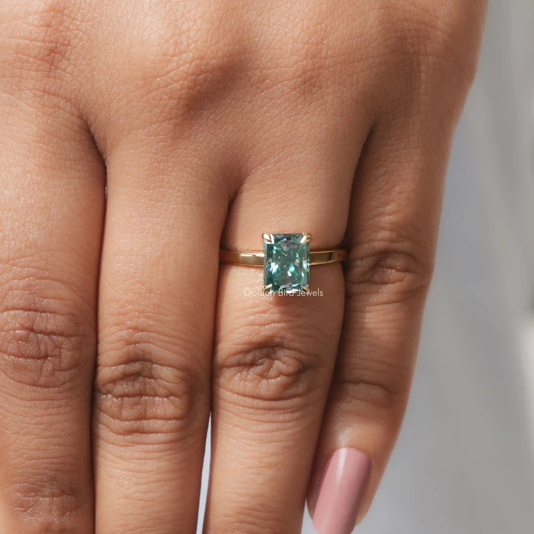 Close-Up View of Radiant Cut Solitaire Engagement Ring In Yellow Gold