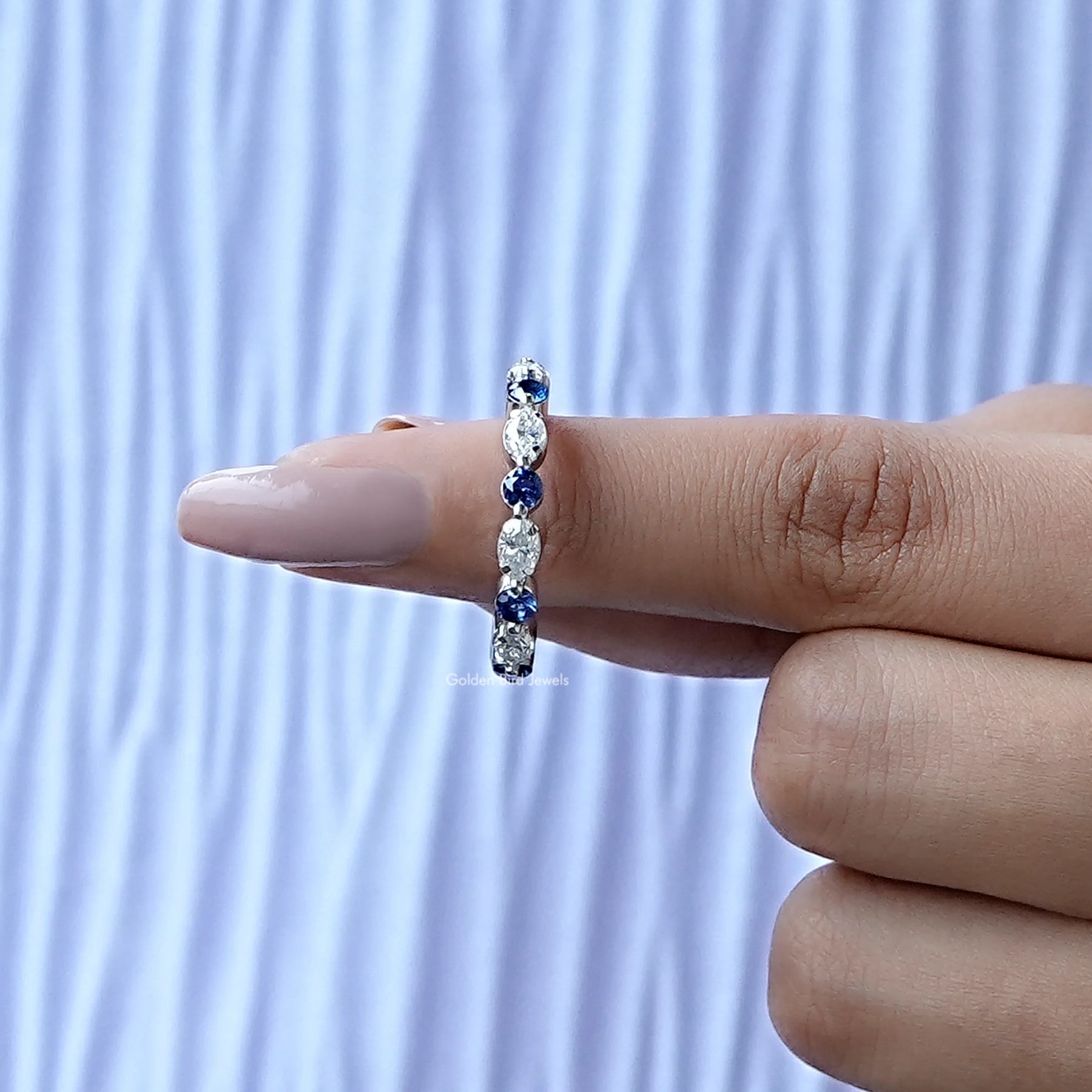 In finger front View of Moissanite Marquise And Round Cut Band In White Gold