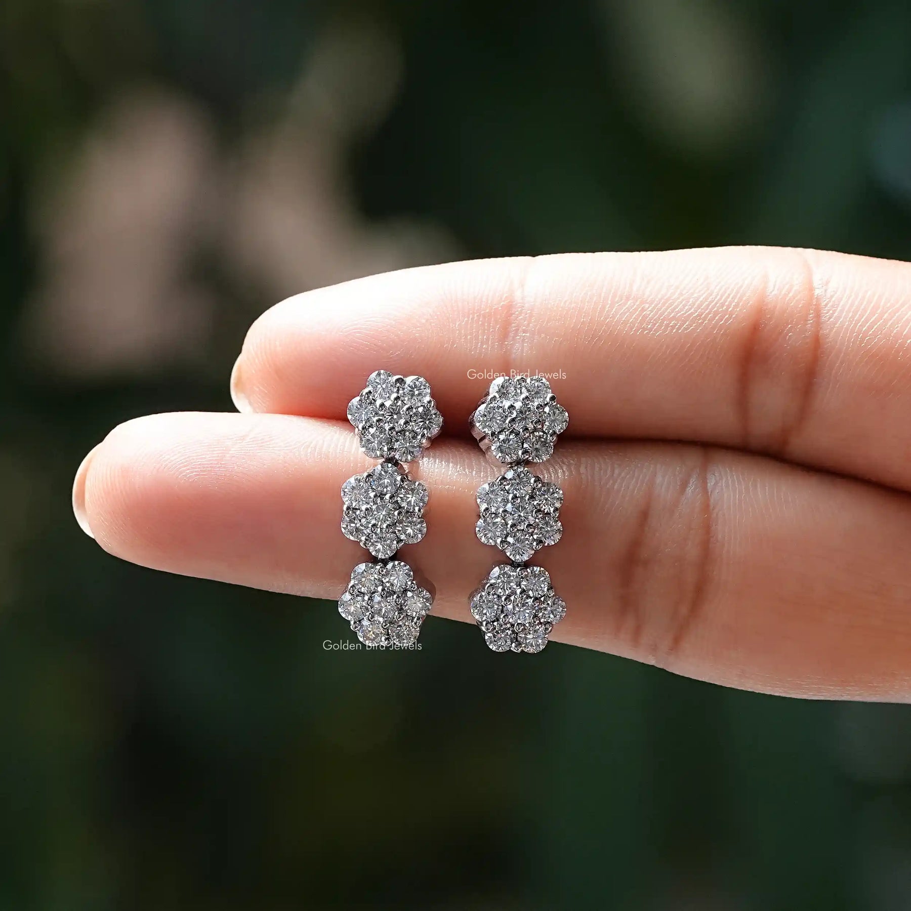 In two two-finger view of Moissanite stud earings in 3 joint row