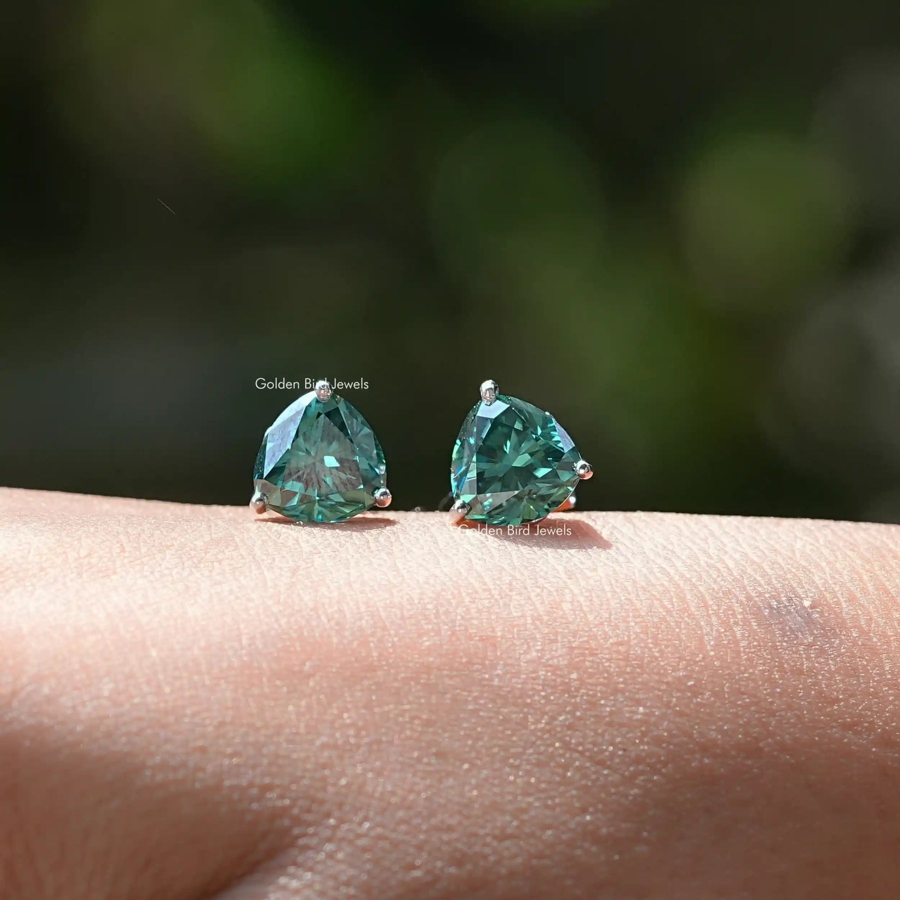 In Hand View Of trillion cut moissanite stud Earrings