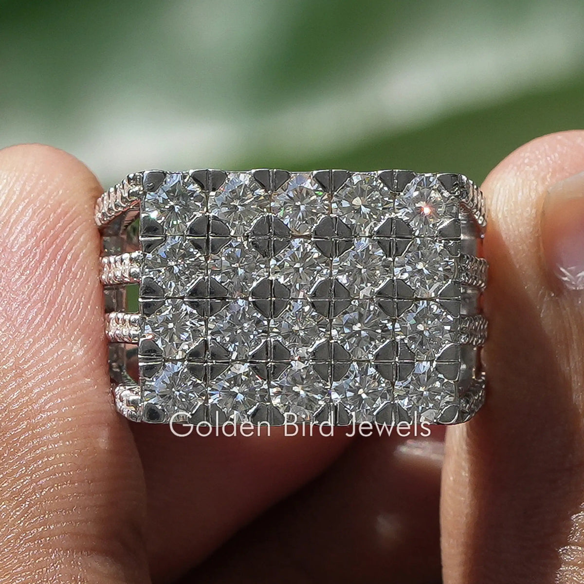 Pave Set Round Diamond Men’s Ring Held Between Fingers