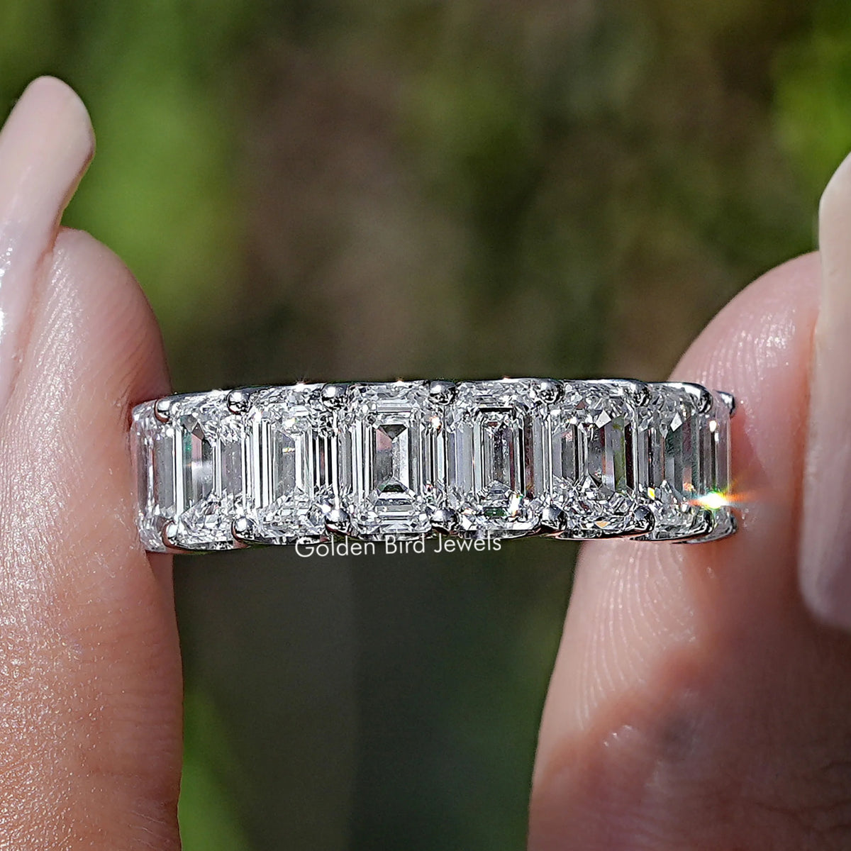 Emerald Cut Lab Diamond Half Eternity Band  Held Between Fingers