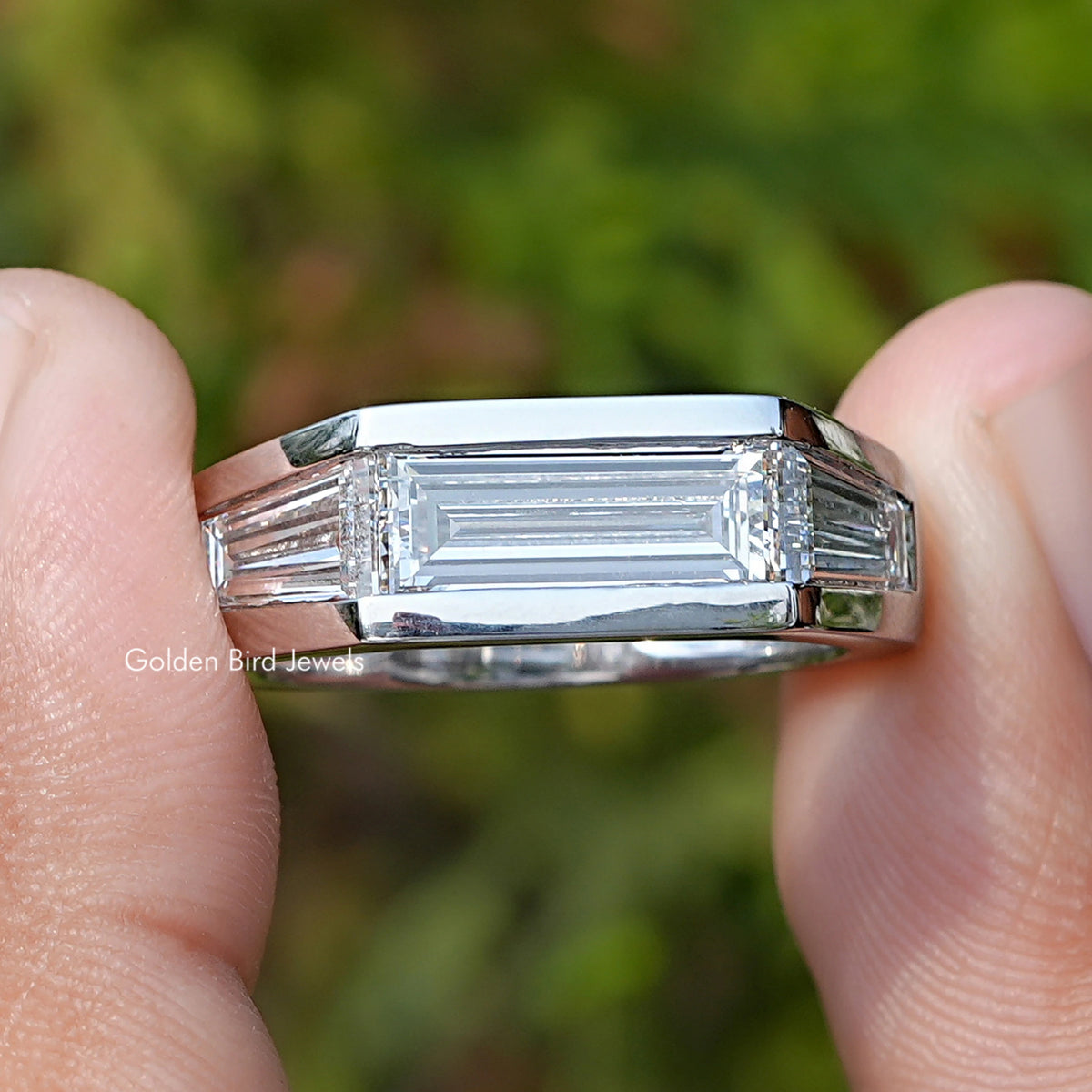 Baguette Cut Lab Grown Diamond Men's Ring Held Between Fingers