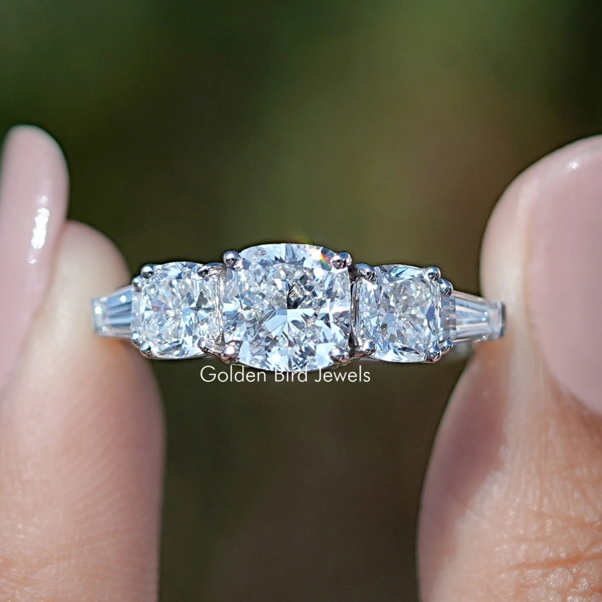 Square Cushion Lab Diamond Five Stone Ring Held Between Fingers