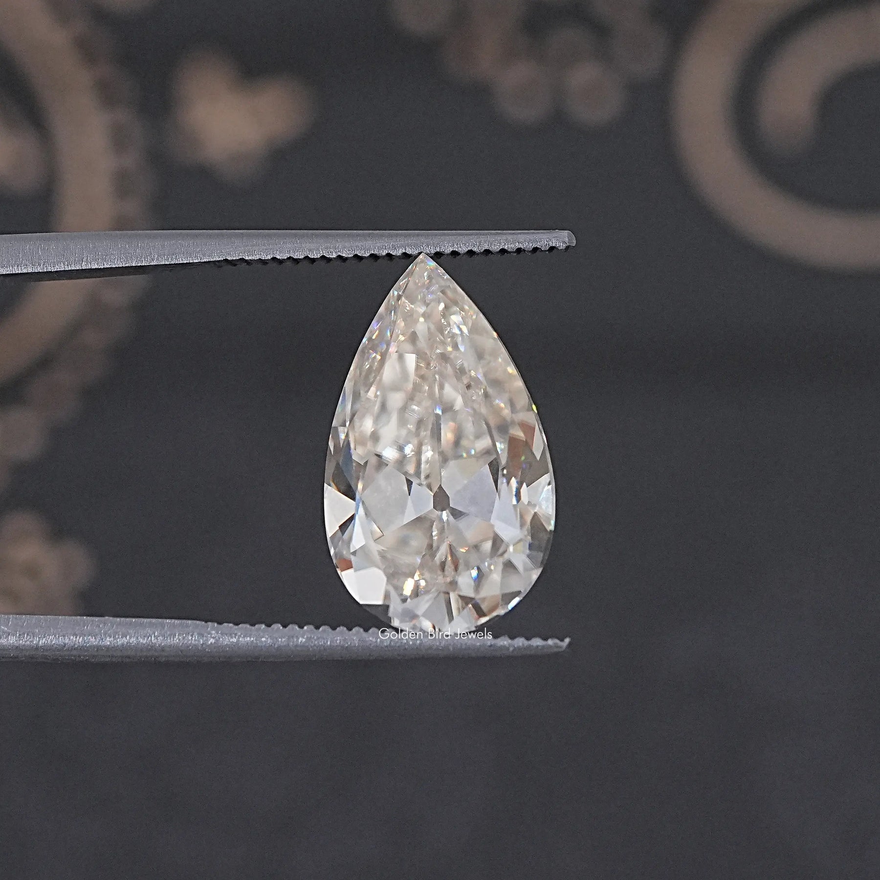 In Tweezer View Of Old Mine Pear Cut Loose Moissanite Stone