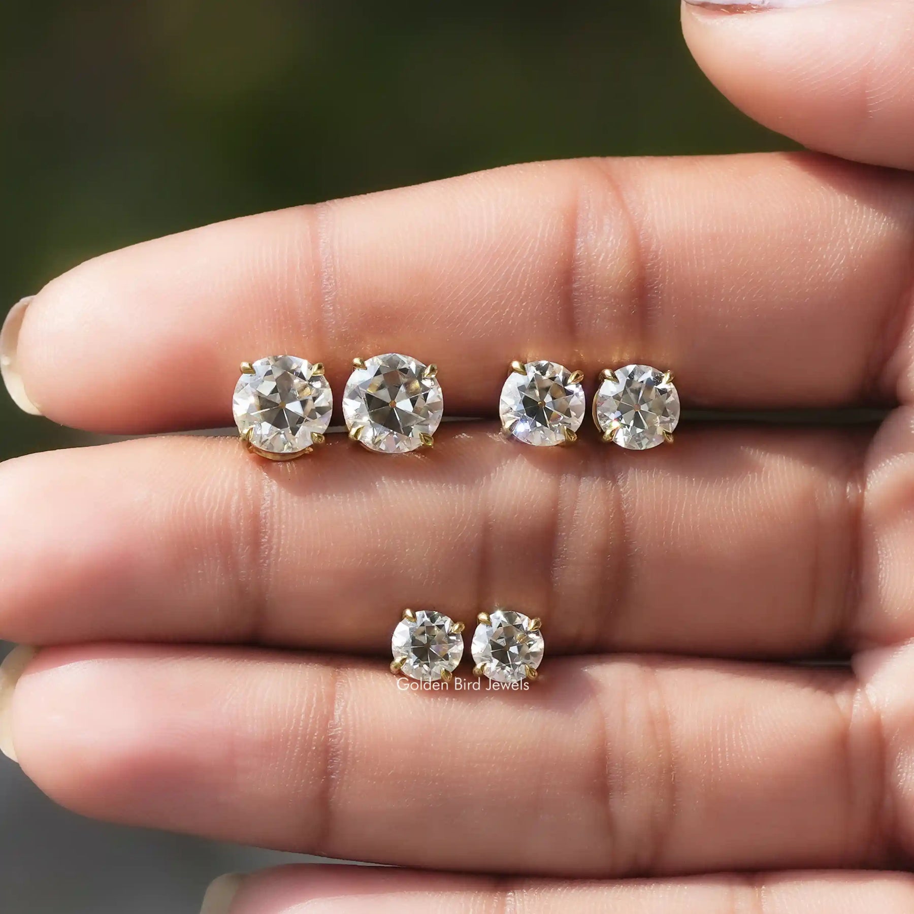 In-Hand View of old European Round Cut Moissanite Stud Earring