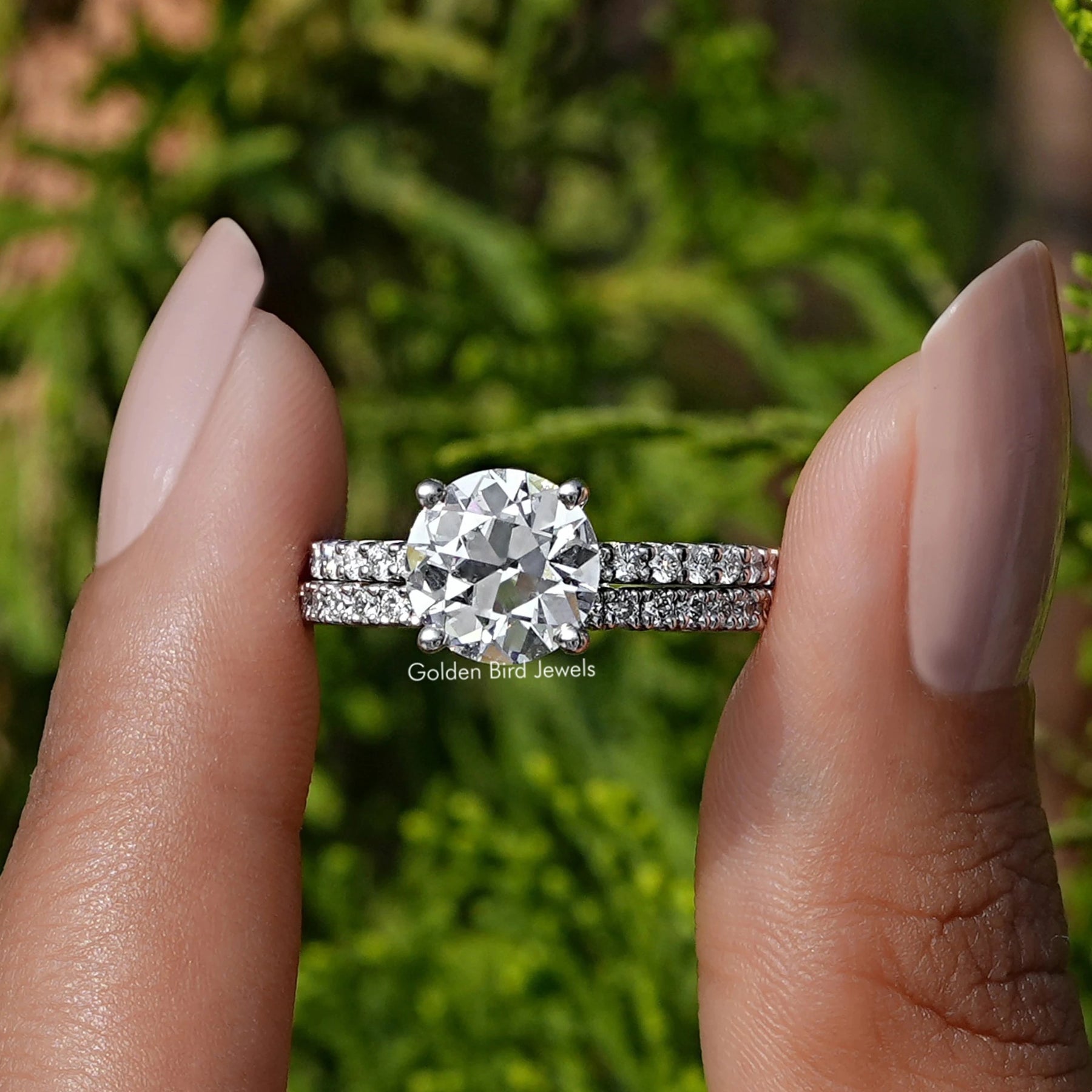 Front view of A Old Round Diamond Ring in two fingers