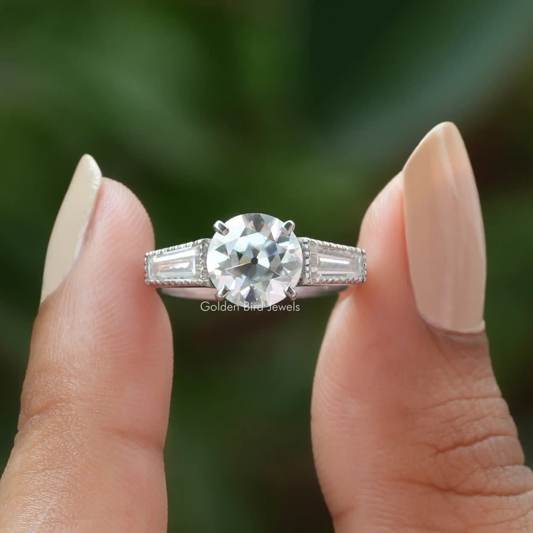 Front View of Old European Round Cut Three Stone Ring In two Fingers