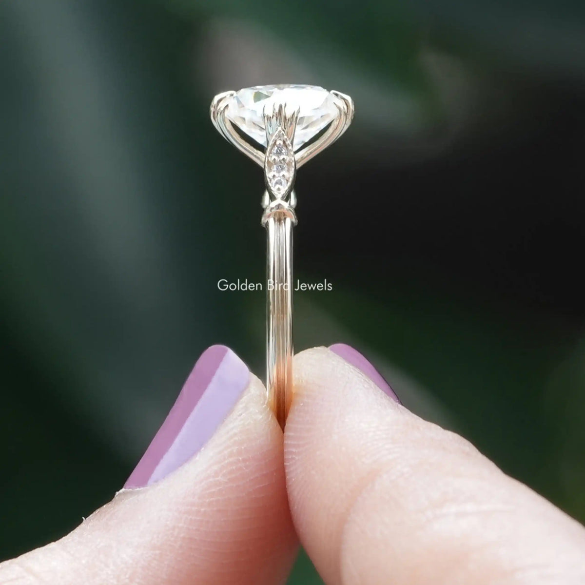 Side View of Cushion Cut Moissanite Accent Stone Ring In two fingers