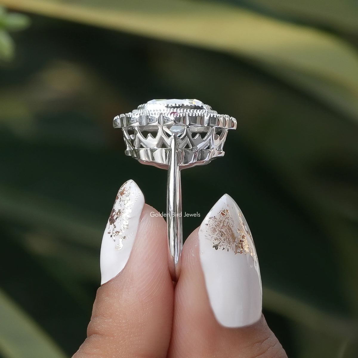 Side View of Old Mine Cushion Cut Halo Moissanite Ring In two fingers