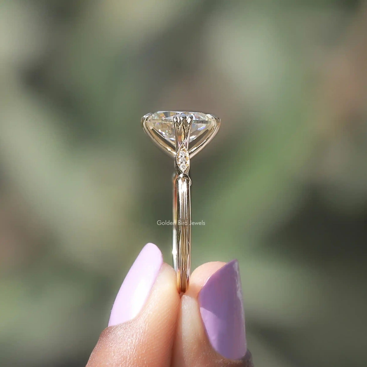 Side View of Cushion Cut Moissanite Ring In two fingers