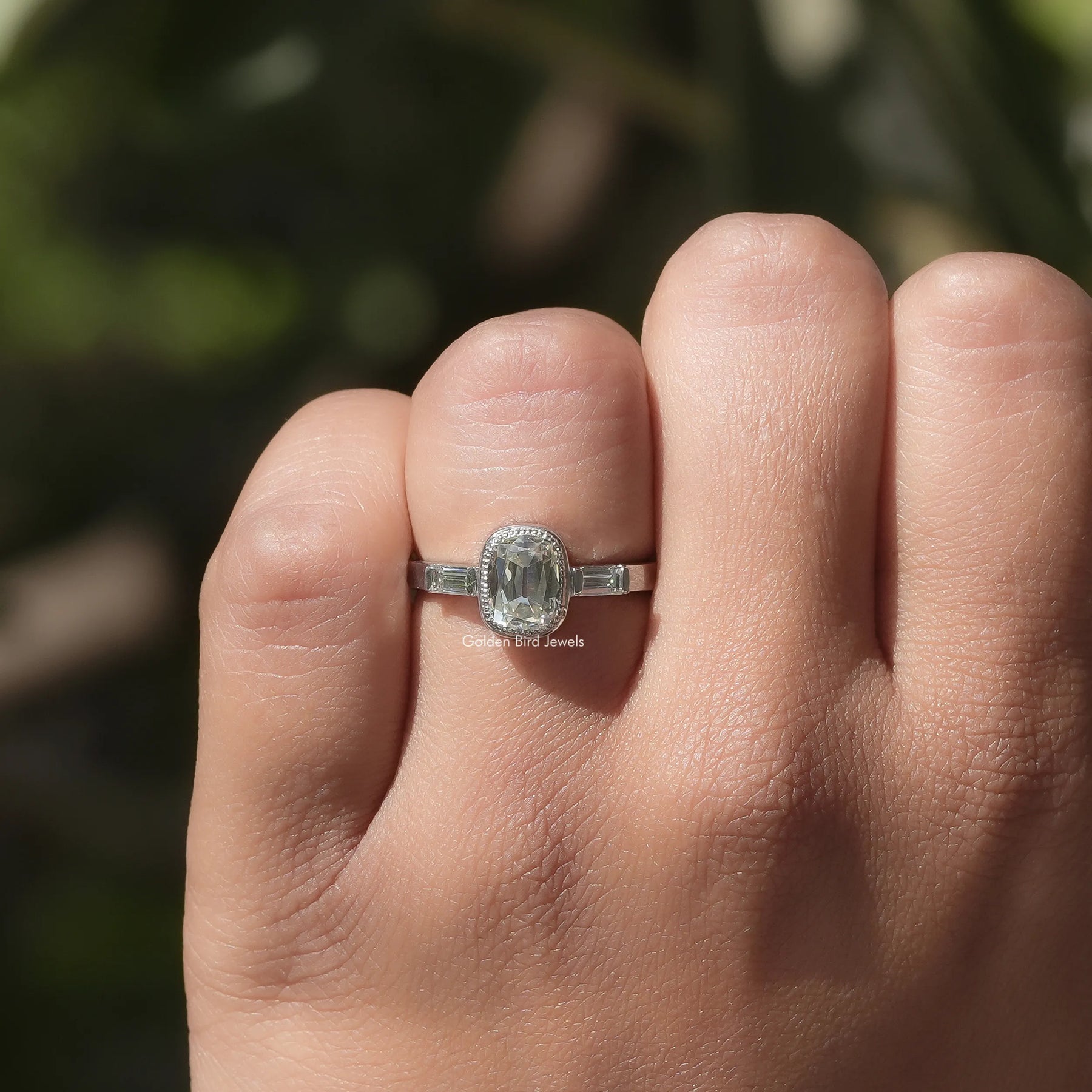Close-Up View of Cushion Cut 3 Stone Ring With Baguette Cut Side Stones In White Gold