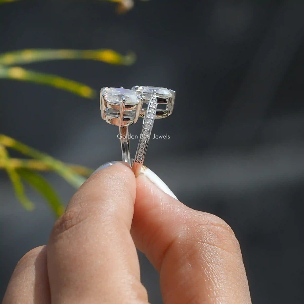 Side View of Old Mine Cushion Cut Moissanite Ring In two fingers