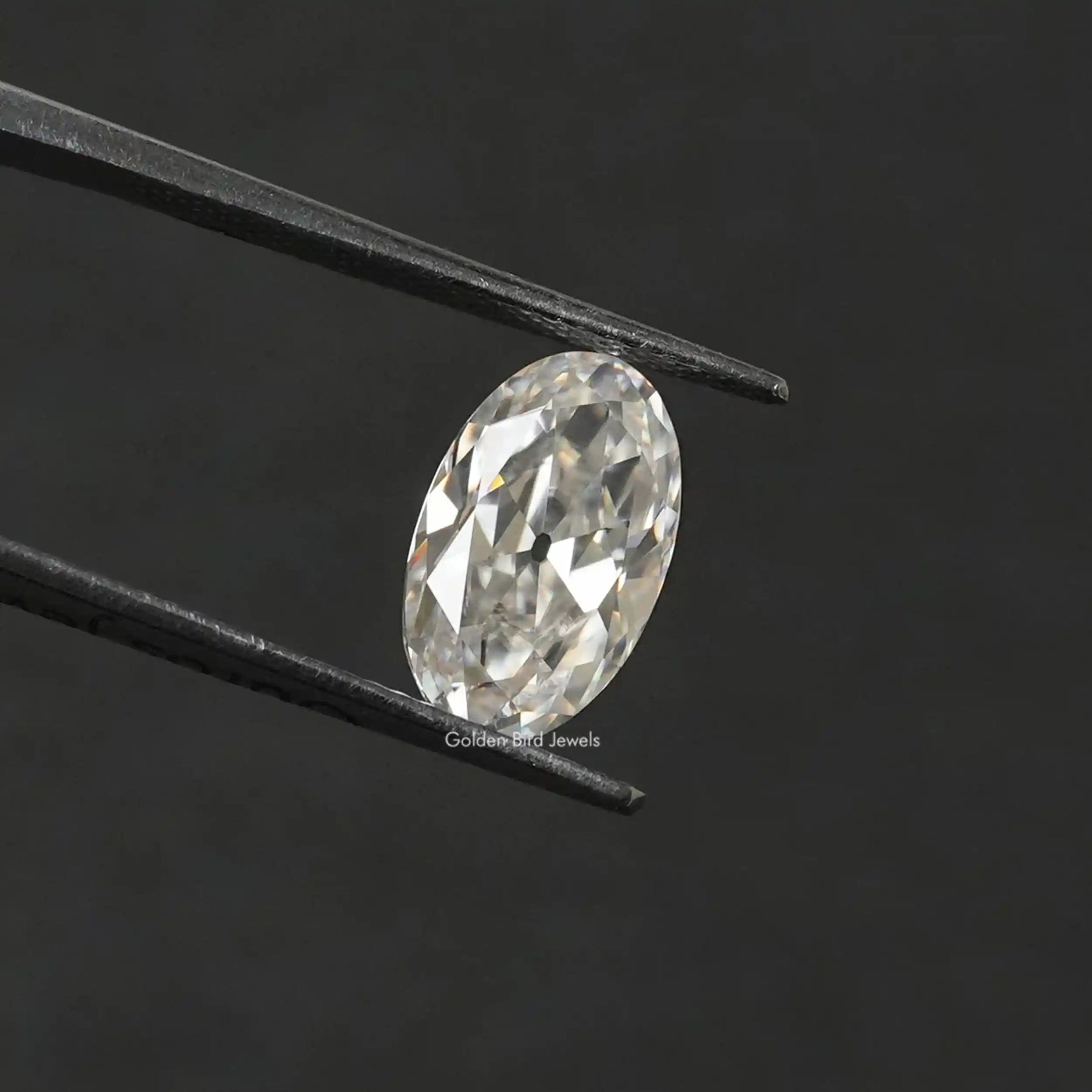 In Tweezer View Of Near Colorless Oval Cut Loose Stone