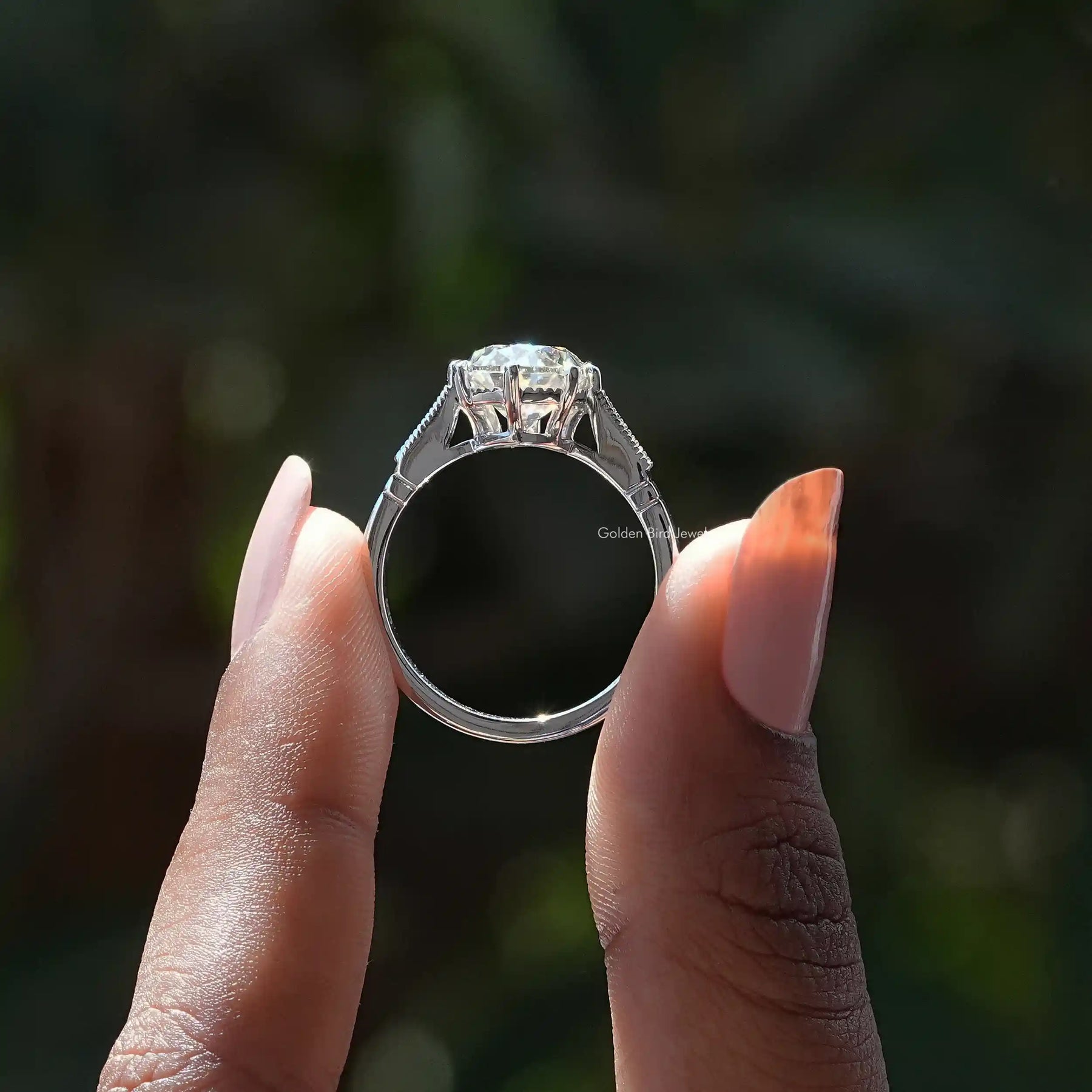 Back View of Oval Cut Moissanite Ring In two fingers