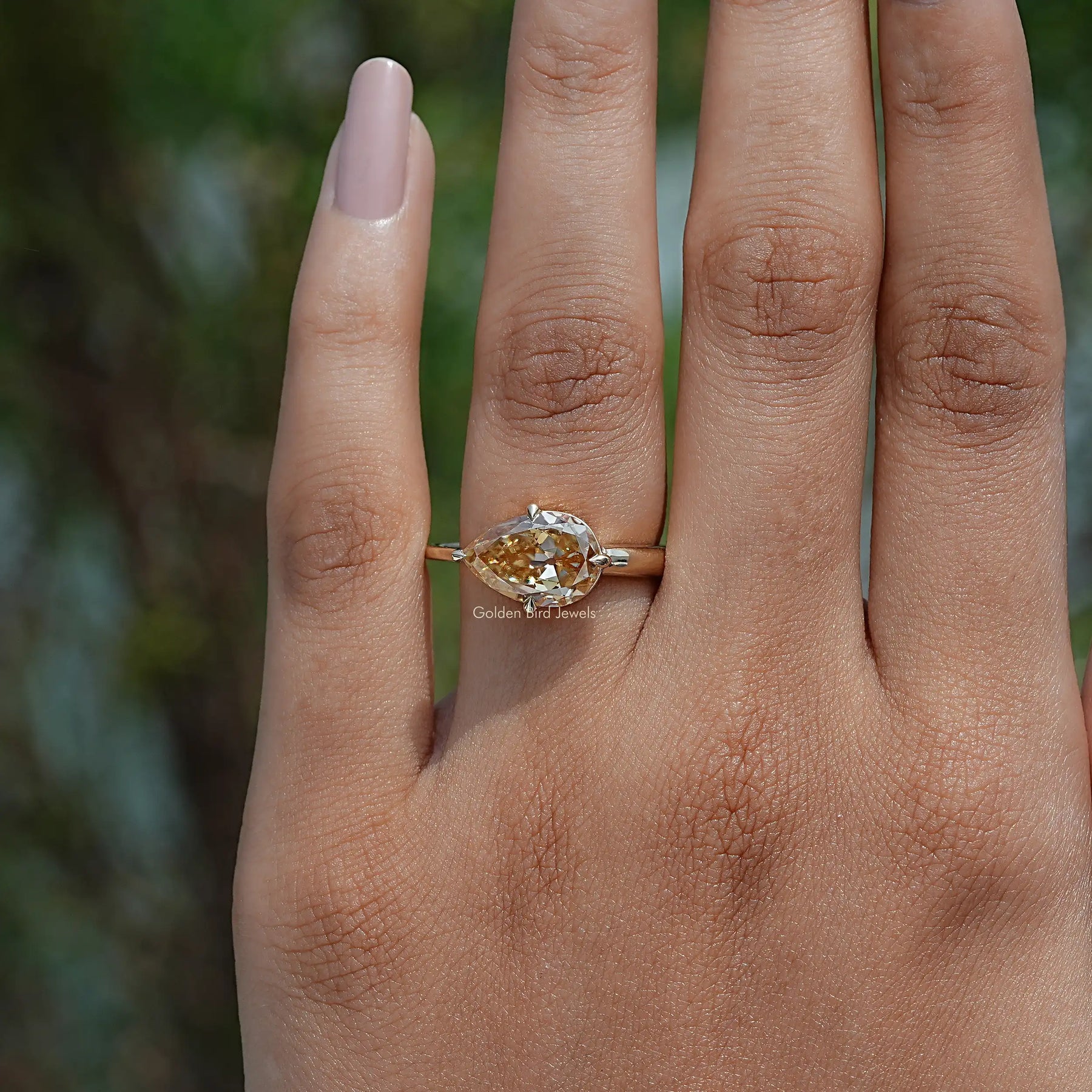 Close-Up View of Pear Cut Moissanite Engagement Ring In Yellow Gold
