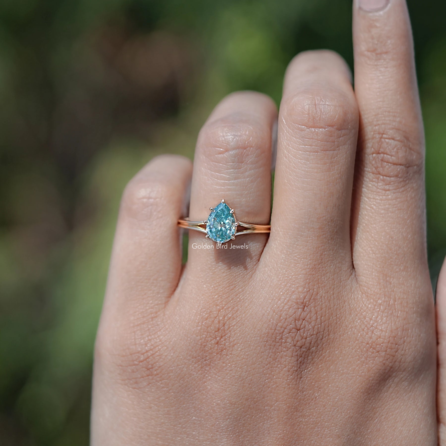 In finger front view of Pear Cut Moissanite Engagement Ring