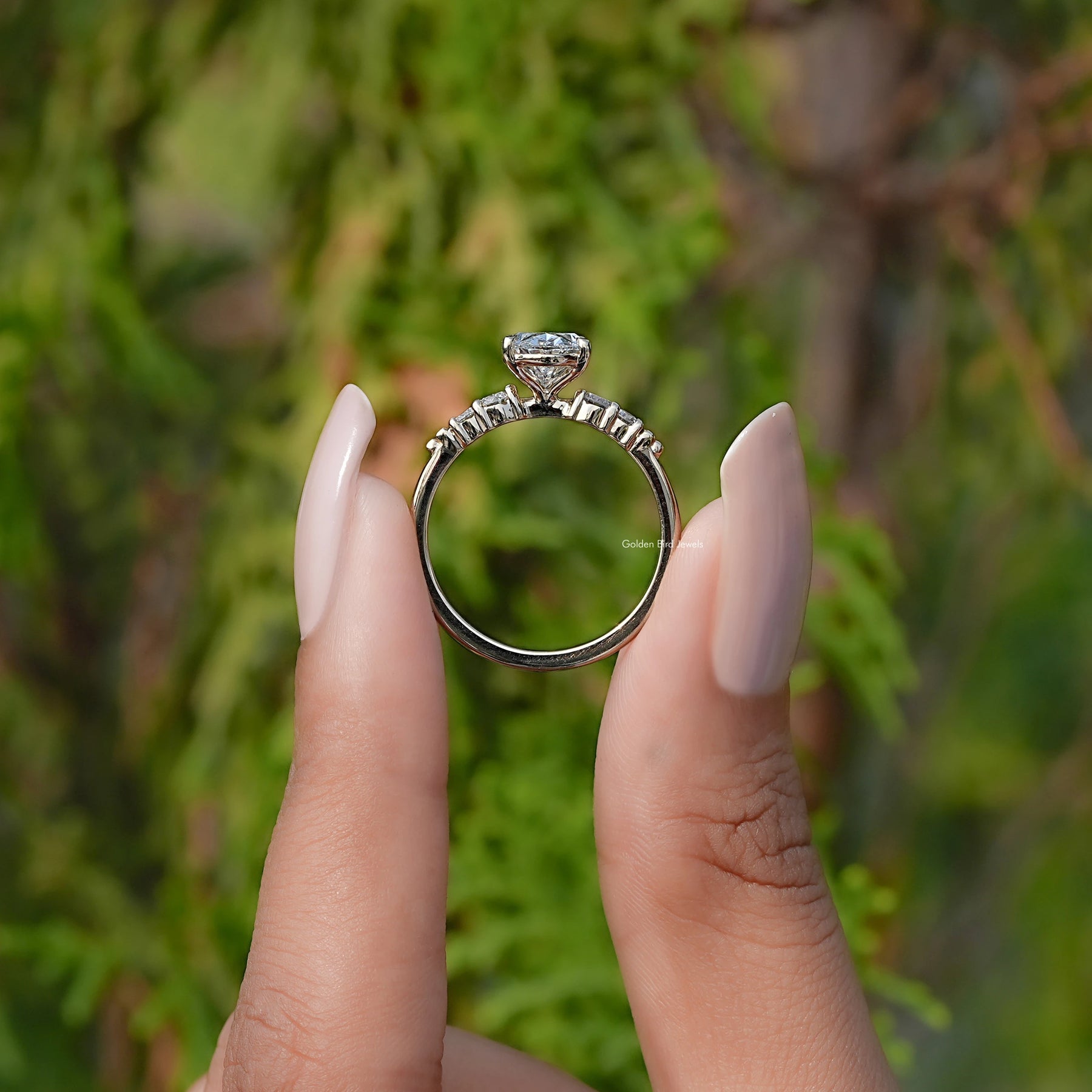 Back View of Oval And Round Cut Lab Grown Diamond Ring In two fingers