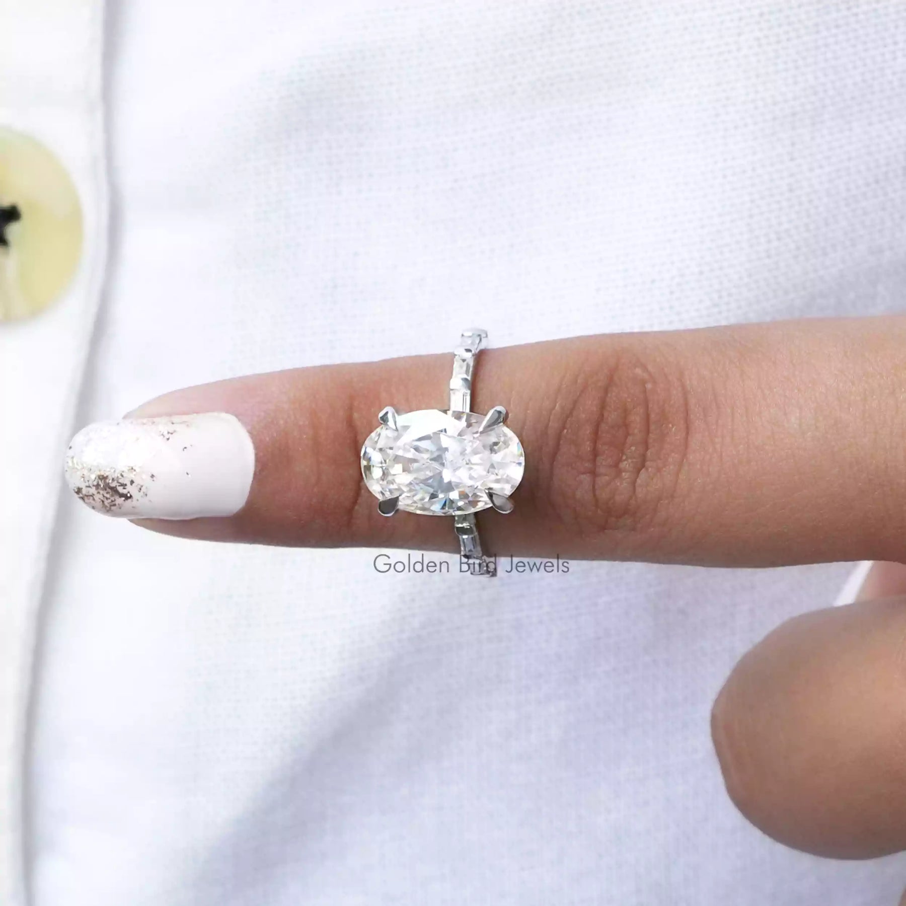 In finger front View of Oval And Baguette Cut Moissanite Ring