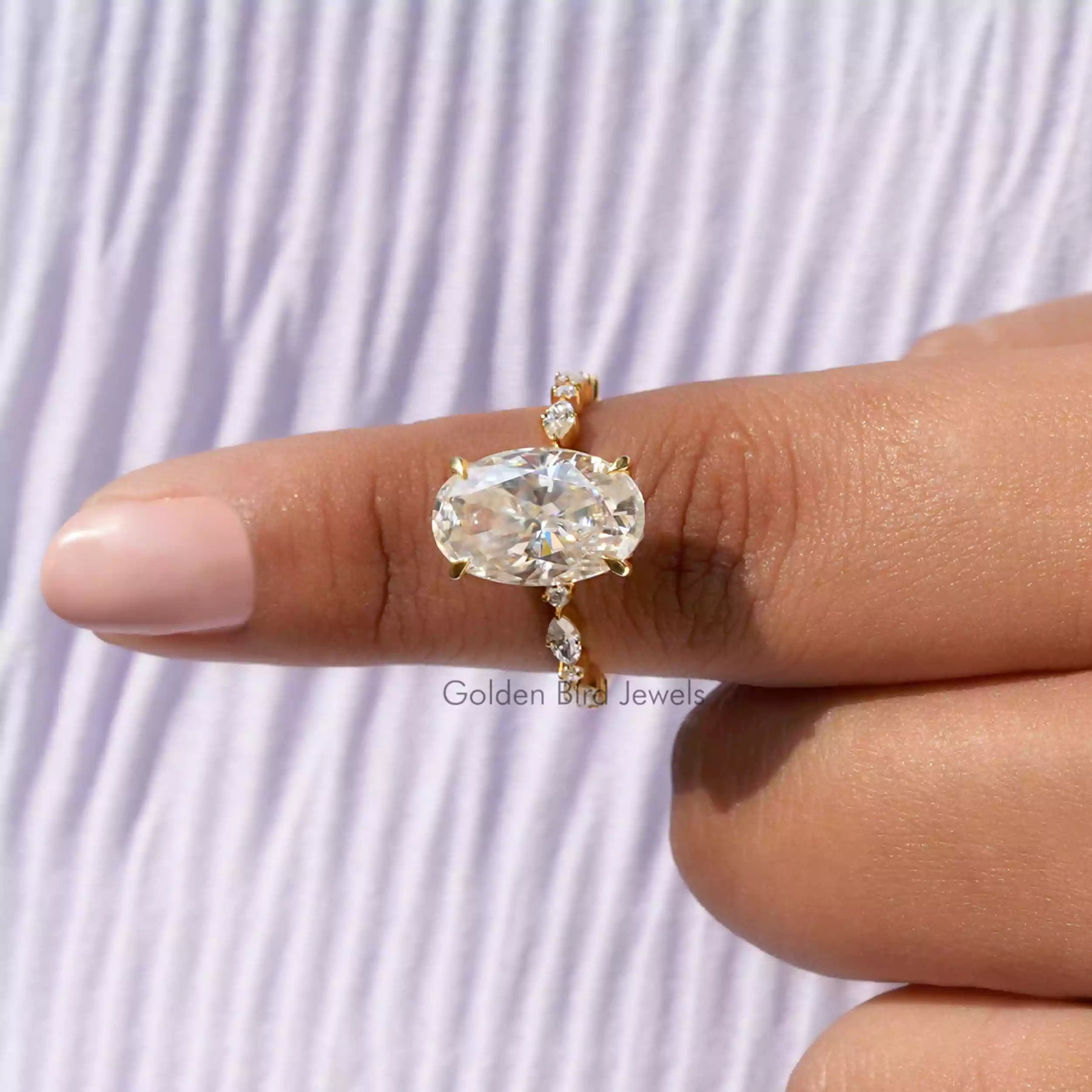 In finger front View of Moissanite Crushed Ice Oval Cut Accent Ring