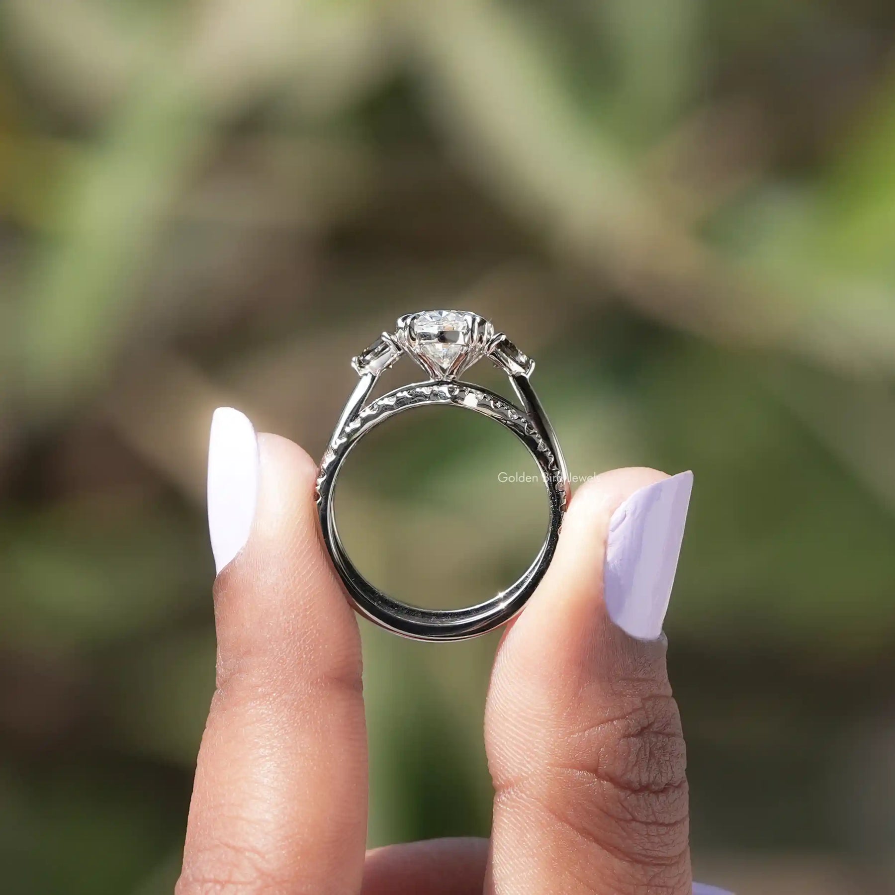 Back View of Oval Cut Lab Diamond Bridal Ring In two fingers