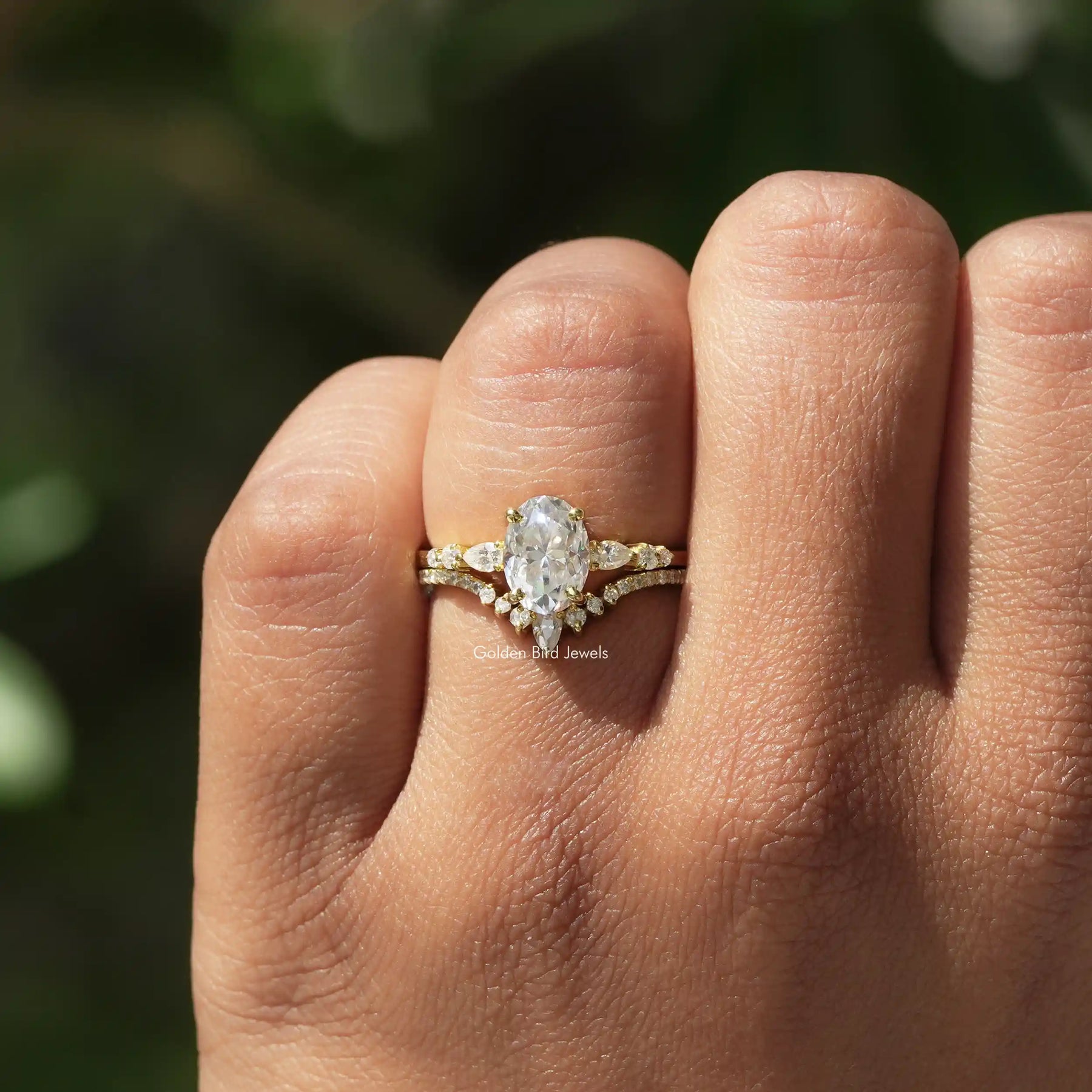 Close-Up View of Oval And Pear Cut Ring Set In Yellow Gold