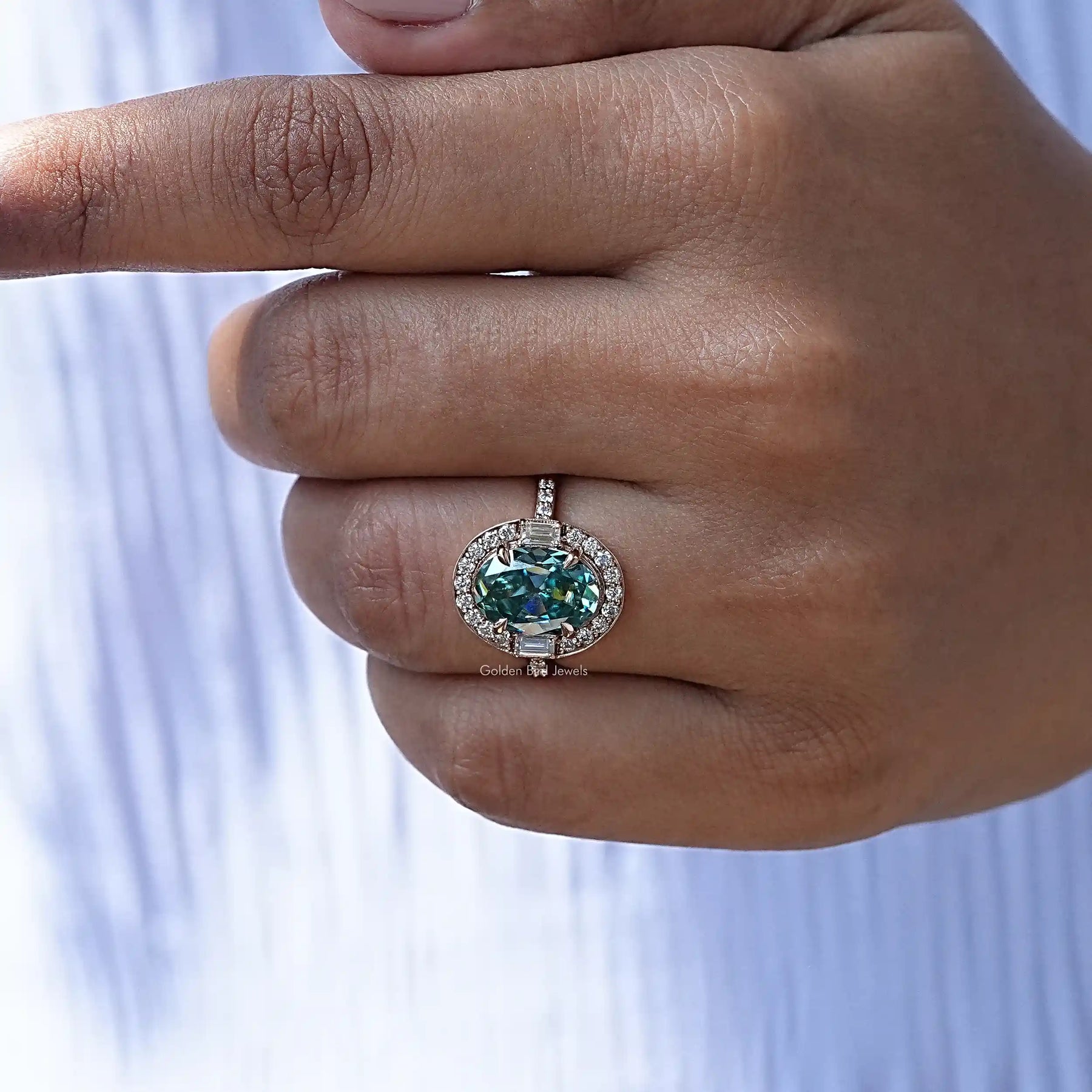 Detailed View Of Blue Oval Cut Halo Engagement Ring In Yellow Gold